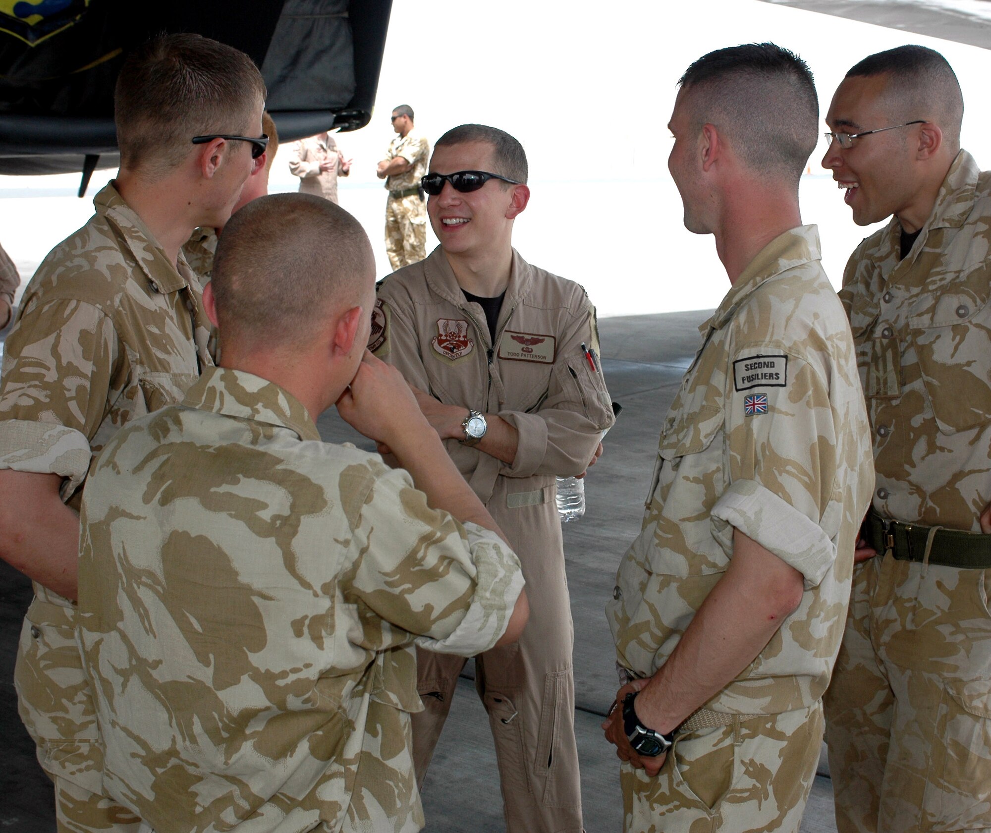 Capt. Todd Patterson, a B-1B Lancer pilot with the 34th Expeditionary Bomb Squadron, chats with British infantrymen from the Royal Regiment of Fusiliers during a tour of their deployed location May 2. The bomber aircrews were called upon daily to provide close-air support for the fusiliers through bombing and shows of force and presence. (U.S. Air Force photo/Senior Airman Erik Hofmeyer) 

