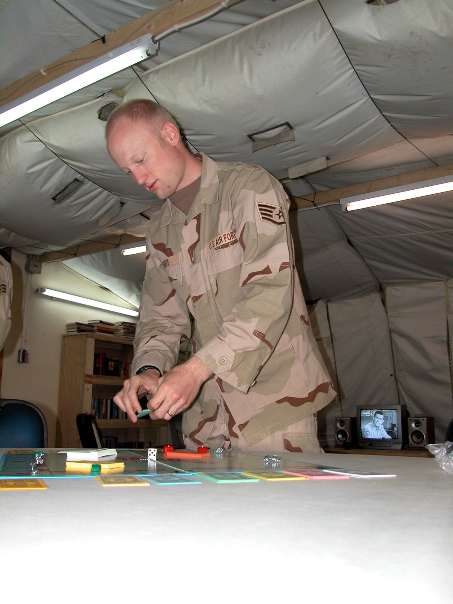 Staff Sgt. Brian Marts sets up a board games available at the new Troy's Place Airmen's Ministry Center May 4 at Balad Air Base, Iraq. The center is named in honor of Maj. Troy Gilbert, an F-16 Fighting Falcon pilot from Luke Air Force Base, Ariz., deployed to Balad AB, who died supporting U.S. ground forces pinned down by anti-Iraqi forces Nov. 27, 2006. The Airmen's Ministry Center is a place where Airmen can spend time in a quiet atmosphere. Sergeant Marts is a wing chaplain assistant. (U.S. Air Force photo/Master Sgt. Bryan Ripple) 
