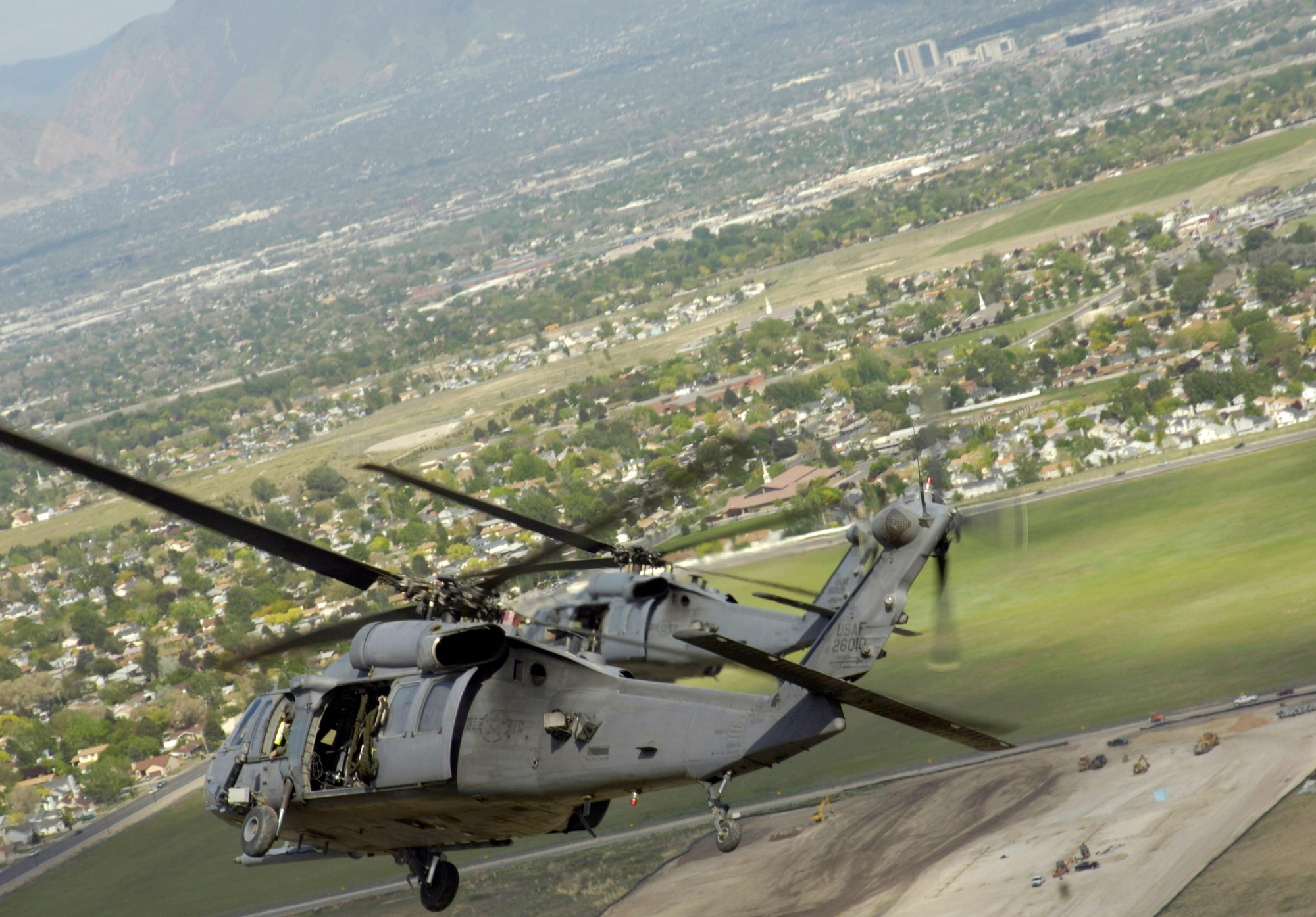 HH-60 Pave Hawks from Nellis Air Force Base, Nev., head out to the Utah Test and Training Range May 3 during a combat search and rescue integration exercise in Sandy, Utah. Members of the 34th Weapons Squadron at Nellis AFB led the search and recovery training. The objective of the exercise was to expand expertise and integration with Utah's 211th Aviation Group AH-64 Apache Joint Rotary Wing, 4th Fighter Squadron F-16 Fighting Falcon Striker assets, special operations forces and conduct extensive joint CSAR operations against surface-to air threats. (U.S. Air Force photo/Master Sgt. Kevin J. Gruenwald) 