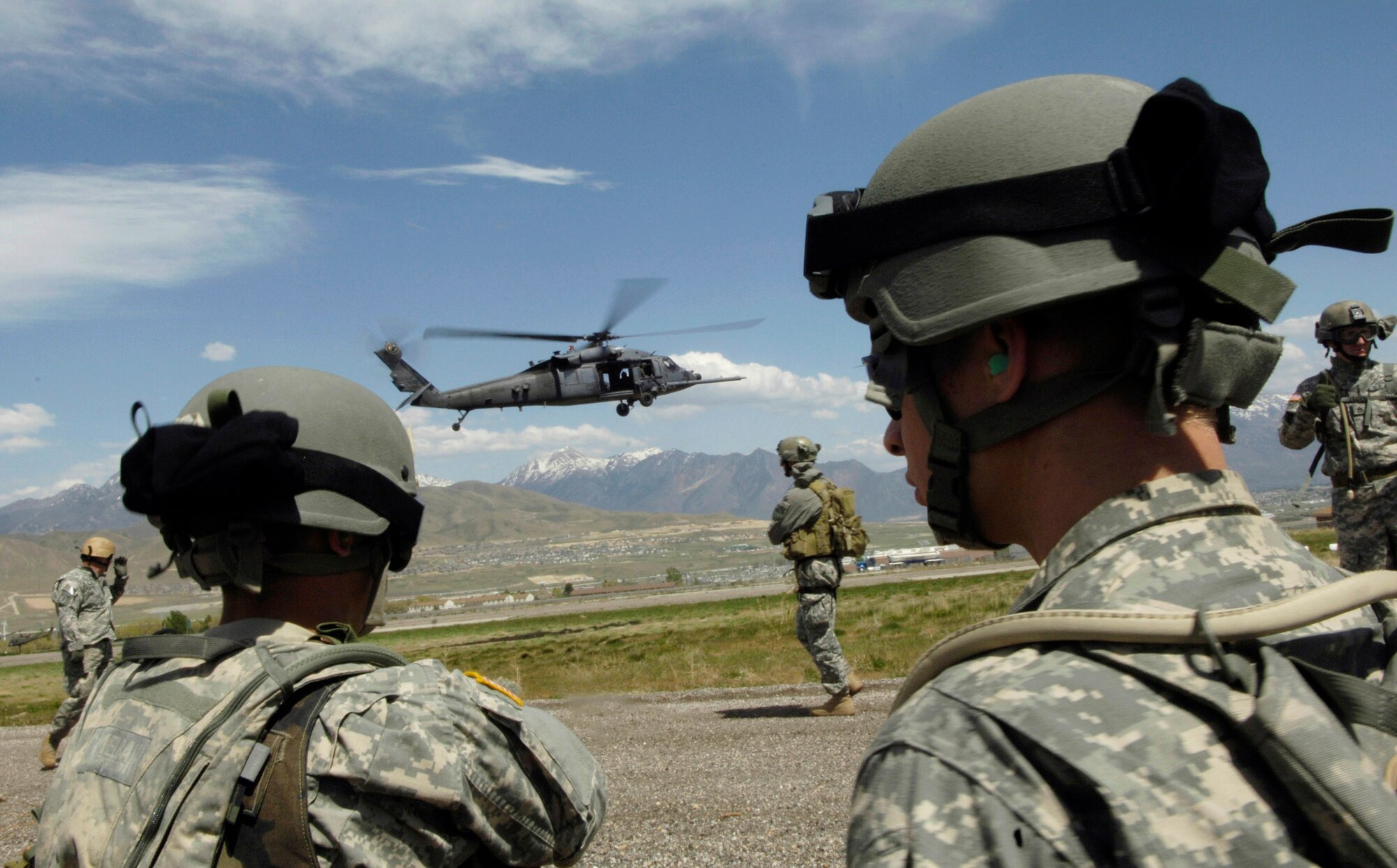 Soldiers from the Utah National Guard move into position for HH-60 Pave Hawk hoist training May 3 during a combat search and rescue integration exercise in Sandy, Utah. Members of the 34th Weapons Squadron from Nellis Air Force Base, Nev., led the search and recovery training. The objective of the exercise was to expand expertise and integration with Utah's 211th Aviation Group AH-64 Apache Joint Rotary Wing, 4th Fighter Squadron F-16 Fighting Falcon Striker assets, special operations forces and conduct extensive joint CSAR operations against surface to air threats. (U.S. Air Force photo/Master Sgt. Kevin J. Gruenwald) 
