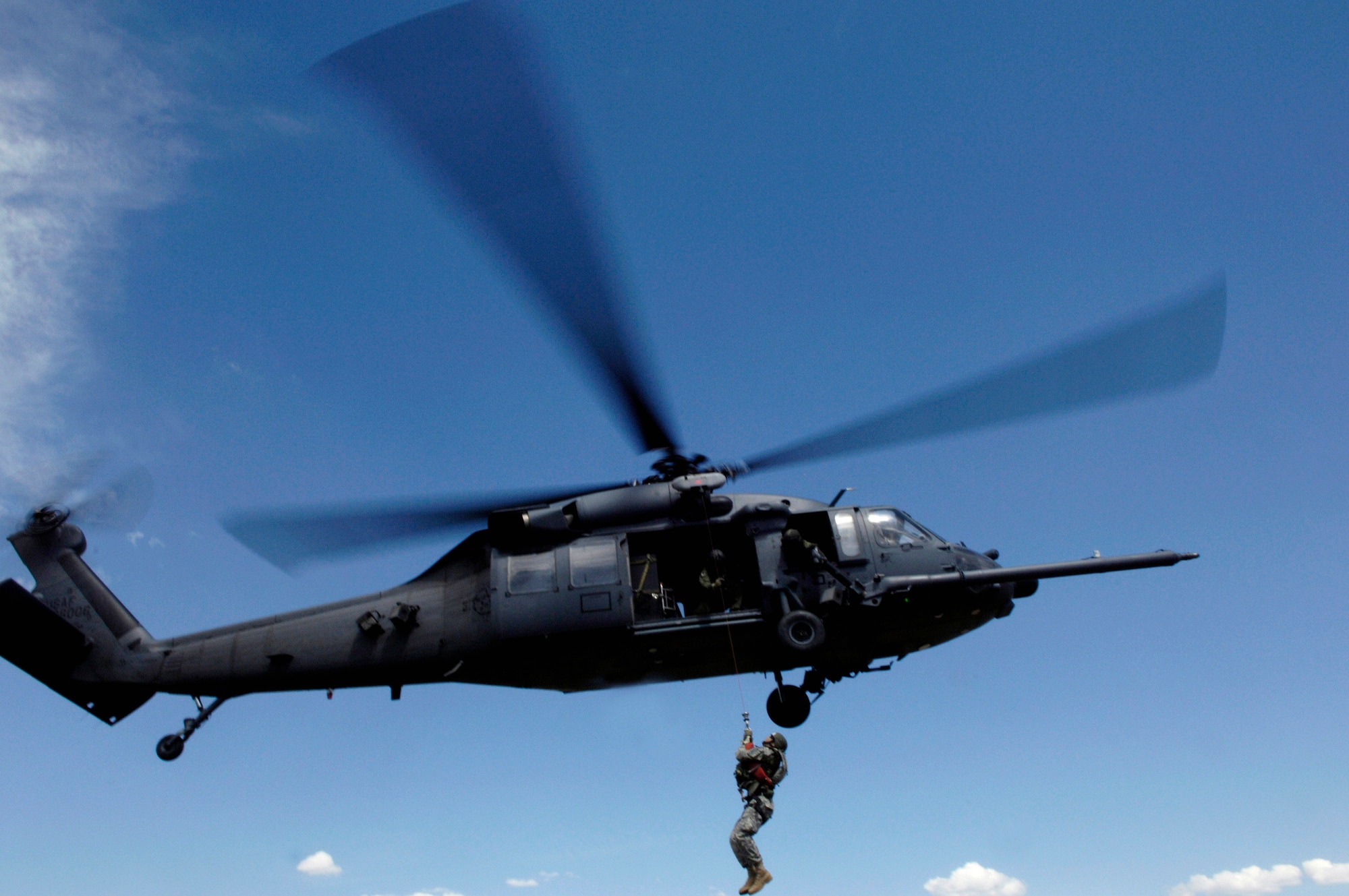 A Utah Army National Guard Soldier is lifted on board an Air Force HH-60 Pave Hawk over the Utah Test and Training Range May 3 during a combat search and rescue integration exercise held May 2 to 5 in Sandy, Utah. Members of the 34th Weapons Squadron from Nellis Air Force Base, Nev., led the search and recovery training. The objective of the exercise was to expand expertise and integration with Utah's 211th Aviation Group AH-64 Apache Joint Rotary Wing, 4th Fighter Squadron F-16 Fighting Falcon Striker assets, special operations forces and conduct extensive joint CSAR operations against surface-to-air threats. (U.S. Air Force photo/Master Sgt. Kevin J. Gruenwald) 