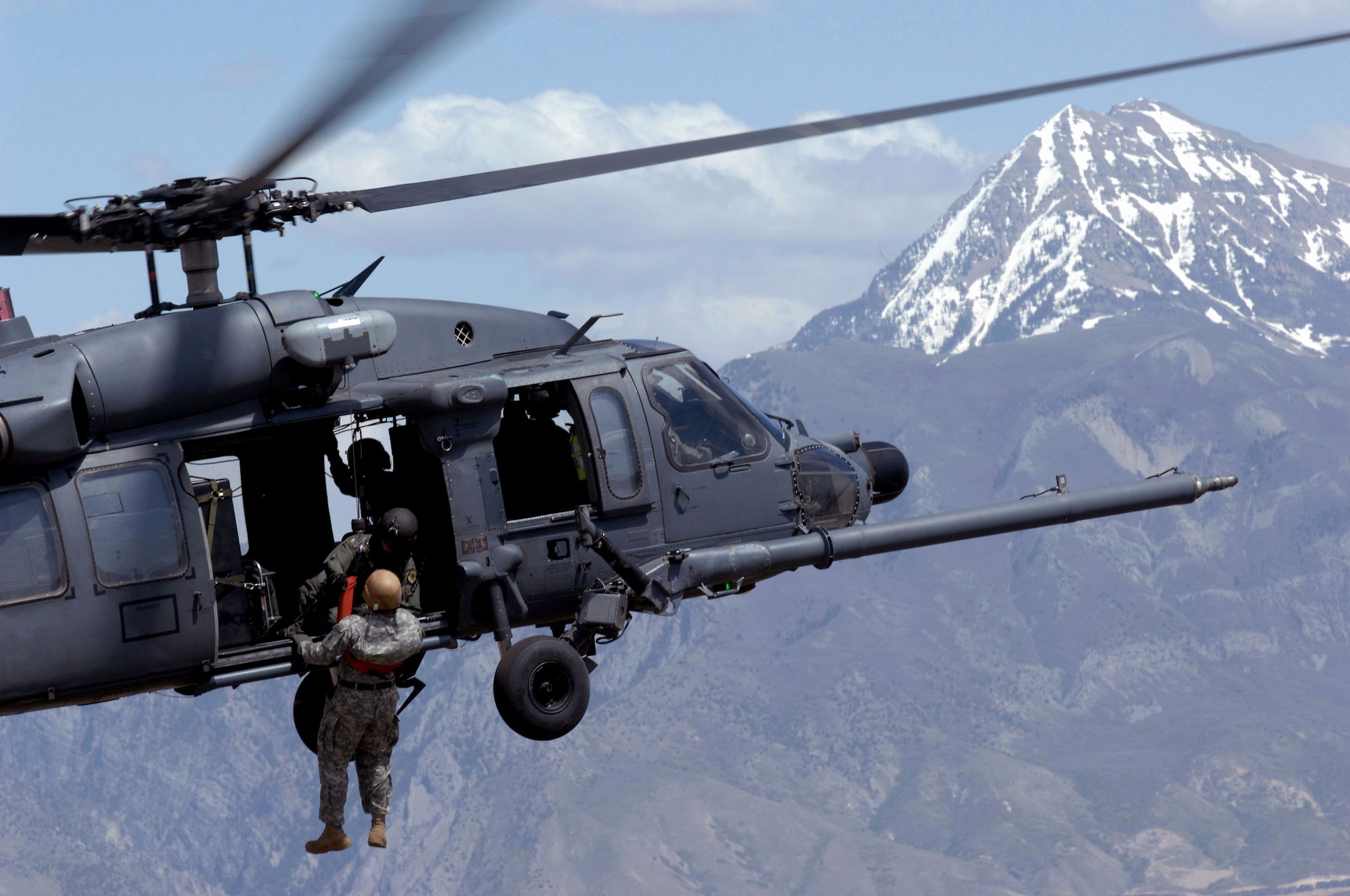 A Utah Army National Guard Soldier is lifted on board an Air Force HH-60 Pave Hawk over the Utah Test and Training Range May 3 during a combat search and rescue integration exercise in Sandy, Utah. The 34th Weapons Squadron from Nellis Air Force Base, Nev., led the search and recovery training. The objective of the exercise was to expand expertise and integration with Utah's 211th Aviation Group AH-64 Apache Joint Rotary Wing, 4th Fighter Squadron F-16 Fighting Falcon Striker assets, special operations forces and conduct extensive joint CSAR operations against surface-to-air threats. (U.S. Air Force photo/Master Sgt. Kevin J. Gruenwald) 
