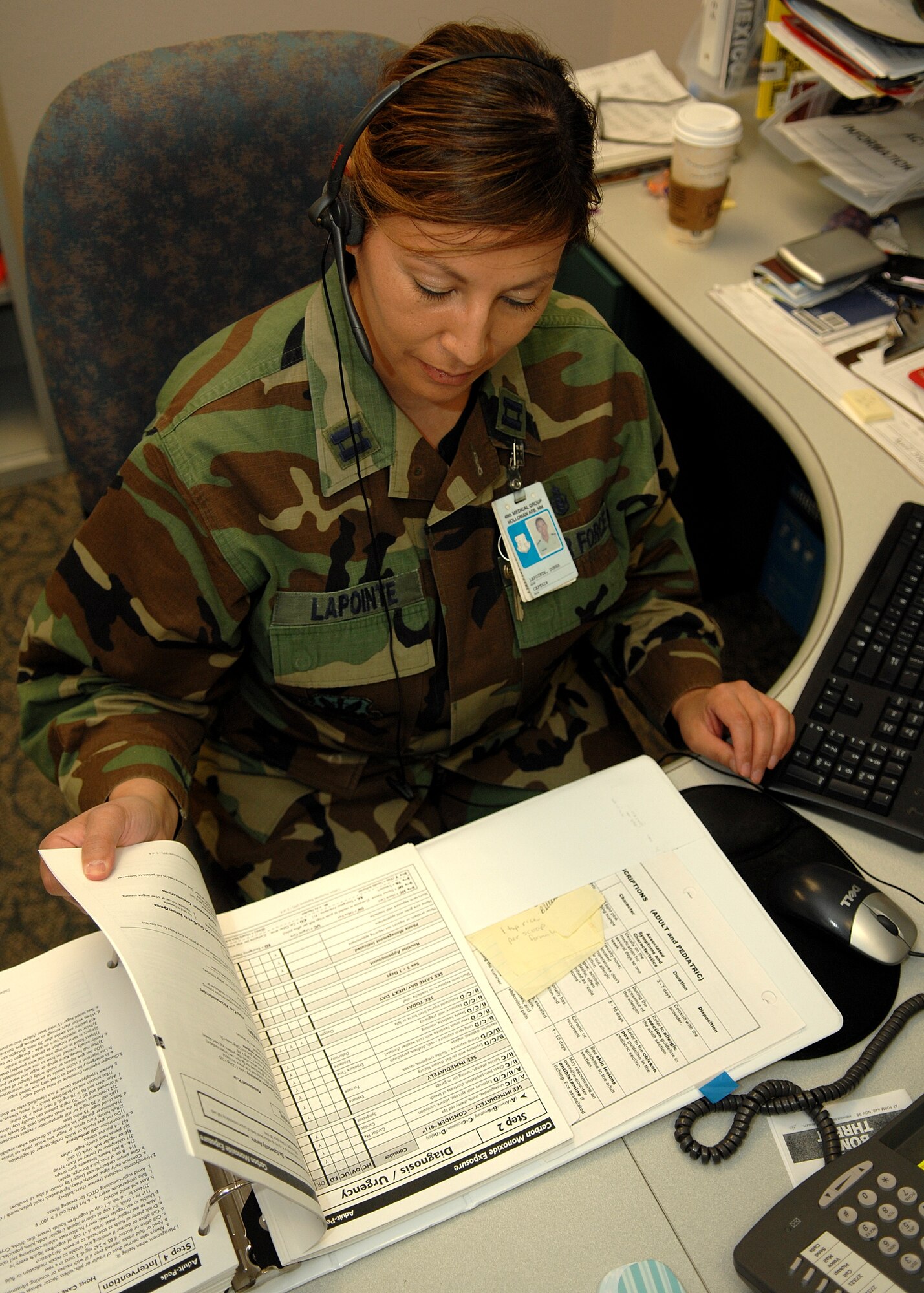 Capt. Donna LaPointe, 49th Medical Operations Squadron, makes a telephone consultation. The Holloman clinic makes more than 1,200 telephone conults a month. The nursing services staff in the medical clinic are being recognized May 6-12 for National Nurses Week for the job they do on a daily basis. (U.S. Air Force photo by Airman 1st Class John Strong)