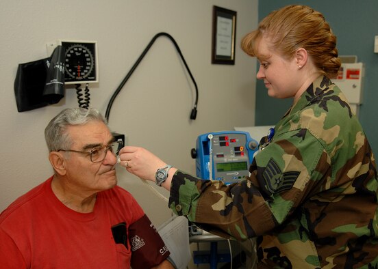 Staff Sgt. Jennifer Pahl, 49th Medical Operations Squadron, takes the temperature of a retiree duriing a routine check up at the Holloman medical clinic. The nursing services staff in the medical clinic are being recognized May 6-12 for National Nurses Week for the job they do on a daily basis. (U.S. Air Force photo by Airman 1st Class John Strong)