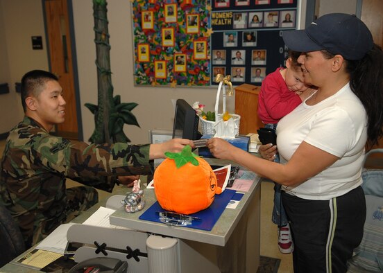 Airman Boshen Yu, 49th Medical Operations Squadron, checks a patient in at the pediatrics counter. The nursing services staff in the medical clinic are being recognized May 6-12 for National Nurses Week for the job they do on a daily basis. (U.S. Air Force photo by Airman 1st Class John Strong)