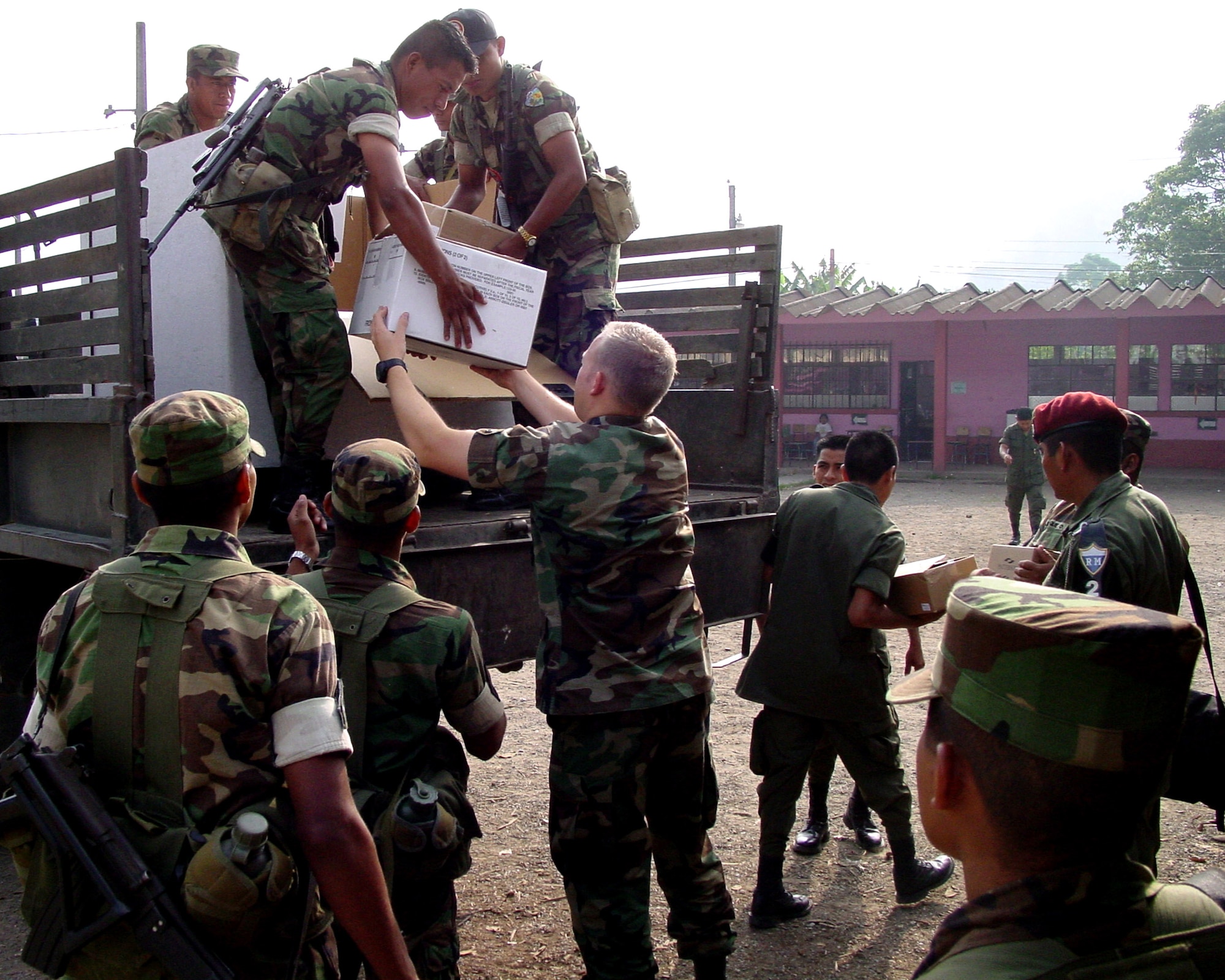 Capt. (Dr.) Daniel Rohweder helps Guatemalan soldiers unload medical supplies during a humanitarian mission to some of the poorest regions of Guatemala. Captain Rohweder, a physician from Vandenberg Air Force Base, Calif.,  was one of 13 medical professionals from various Air Force Space Command bases deployed to the country. More than 8,000 patients during the 10-day mission in April. (U.S. Air Force photo)                       