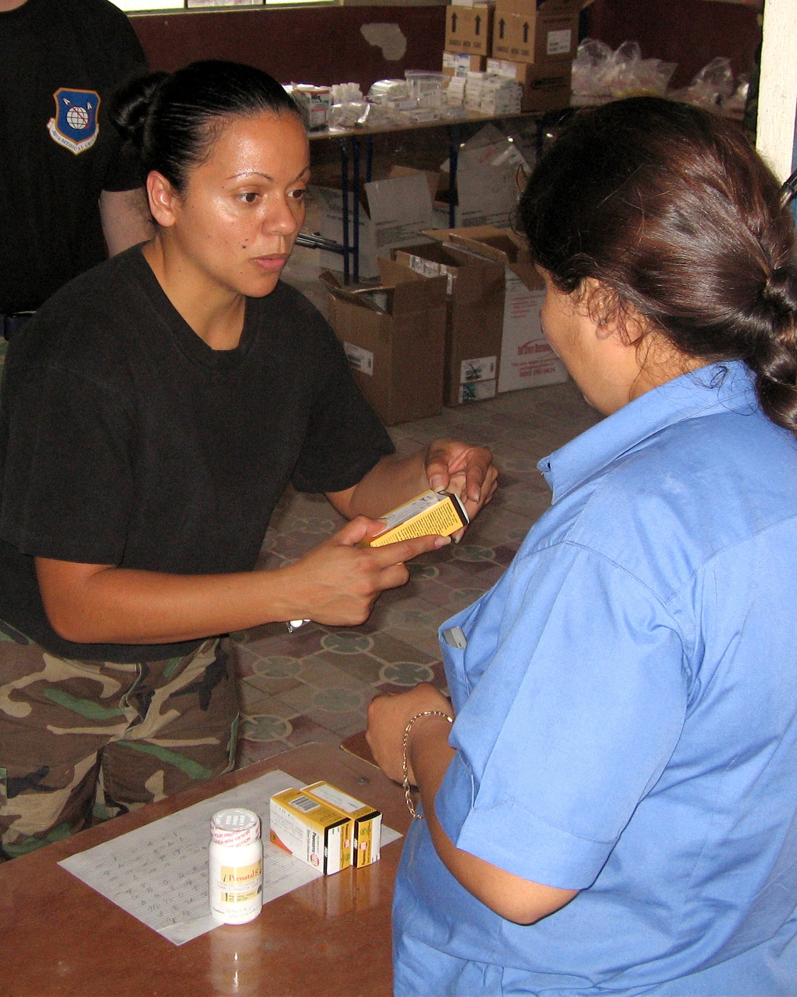 Staff Sgt. Nilsa Ramos, a pharmacy technician from Patrick Air Force Base, Fla., dispenses medicine to a Guatemalan woman during a 10-day humanitarian mission to the area in April. A team of 13 medical professionals from Air Force Space Command saw more than 8,000 patients during that time. (U.S. Air Force photo)