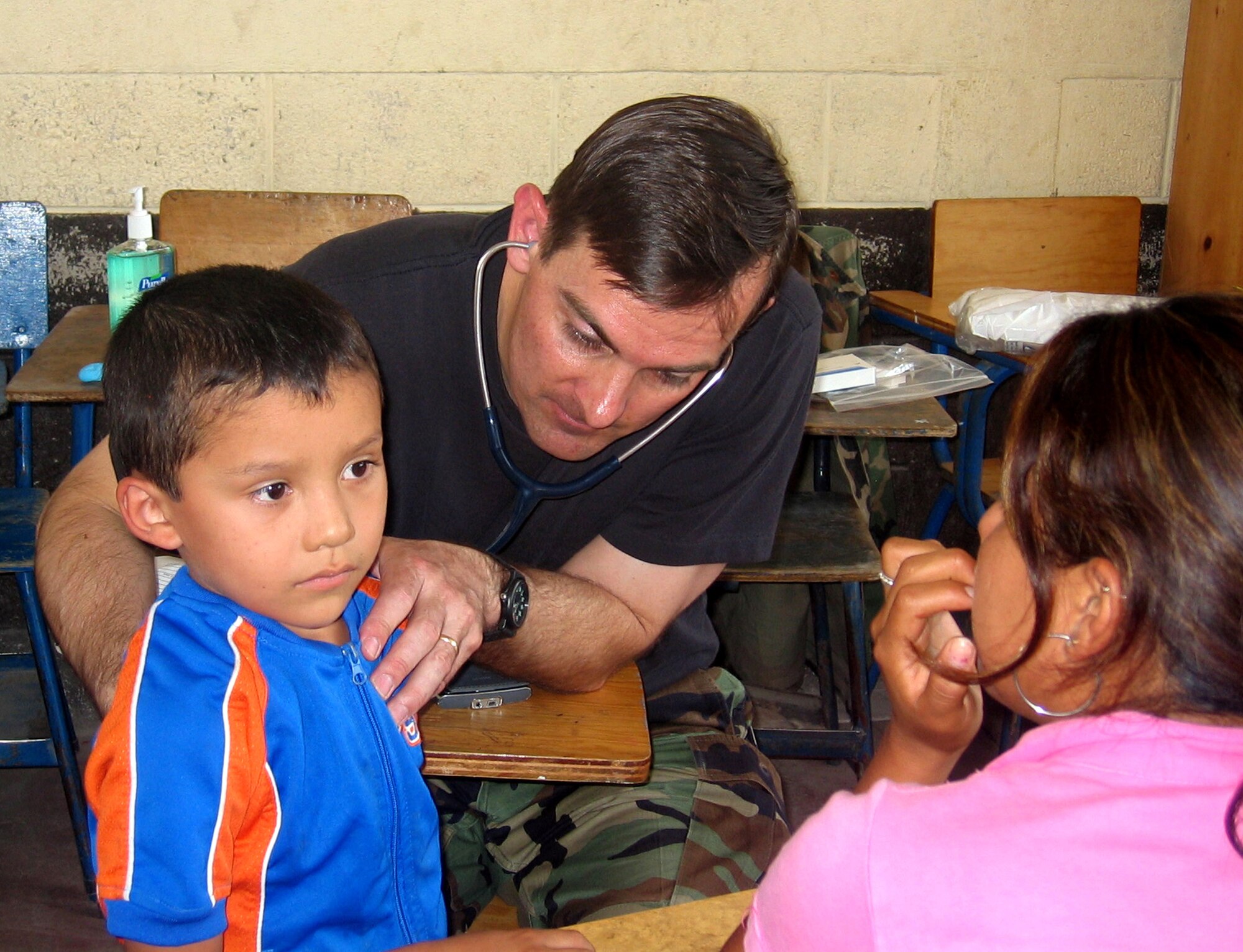 Maj. (Dr.) Michael Stevens, a pediatrician from Peterson Air Force Base, Colo., listens to a Guatemalan child's heartbeat, as the boy's mother looks on. Doctor Nelson was part of a team of 13 medical professionals from Air Force Space Command that was sent to Guatemala for a 10-day humanitarian mission in April. The team saw more than 8,000 patients during that time. (U.S. Air Force photo)