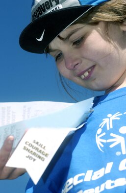 Maura Williams, 8, Vogelweh Elementary School third grader, admires her ribbons after receiving one for the soccer control and pass event May 2 at the U.S. Army Garrison Kaiserslautern's 24th Annual Special Olympics Spring Games 2007 at the Police Academy in Enkenbach-Alsenborn. Athletes received a ribbon for participating at each of the seven competitive events. Photo by Christine June.