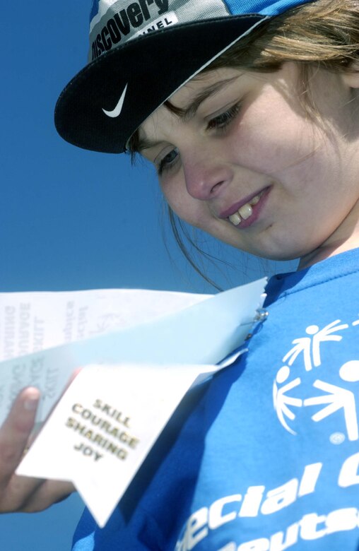 Maura Williams, 8, Vogelweh Elementary School third grader, admires her ribbons after receiving one for the soccer control and pass event May 2 at the U.S. Army Garrison Kaiserslautern's 24th Annual Special Olympics Spring Games 2007 at the Police Academy in Enkenbach-Alsenborn. Athletes received a ribbon for participating at each of the seven competitive events. Photo by Christine June.