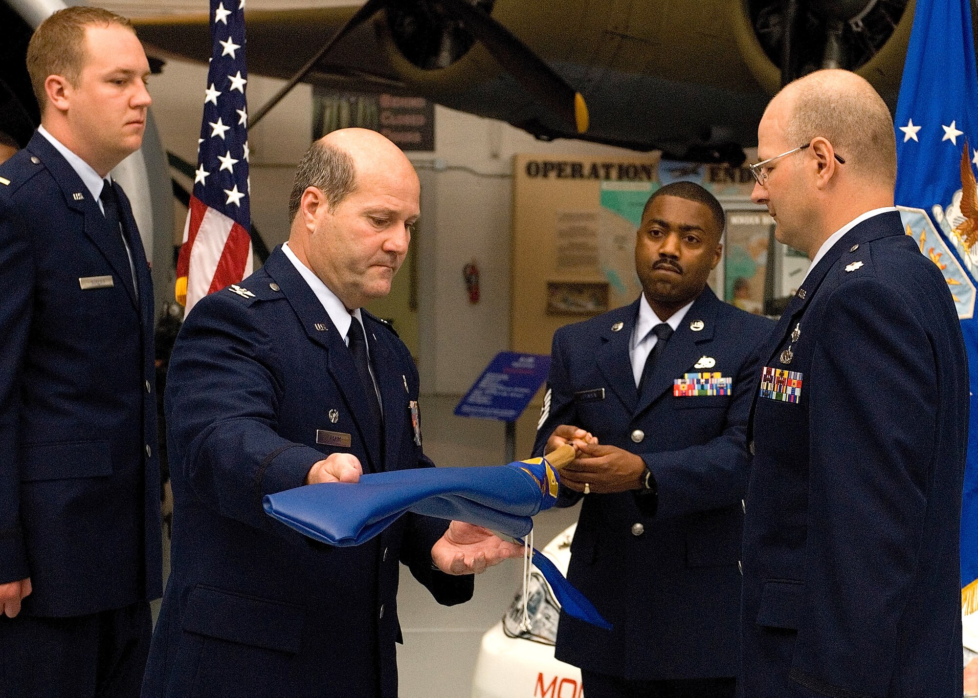 Col. Robert Hamm, 436th Maintenance Group commander, uncases the guidon of the new 736th Aircraft Maintenance Squadron before handing it to Lt. Col. Raymond Briggs, 736th AMXS commander, April 30 at Dover Air Force Base, Del. The 736th AMXS stood up in an assumption-of-command ceremony and will be responsible for maintaining the C-17 Globemaster IIIs, scheduled to start arriving in June. (U.S. Air Force photo/Roland Balik)