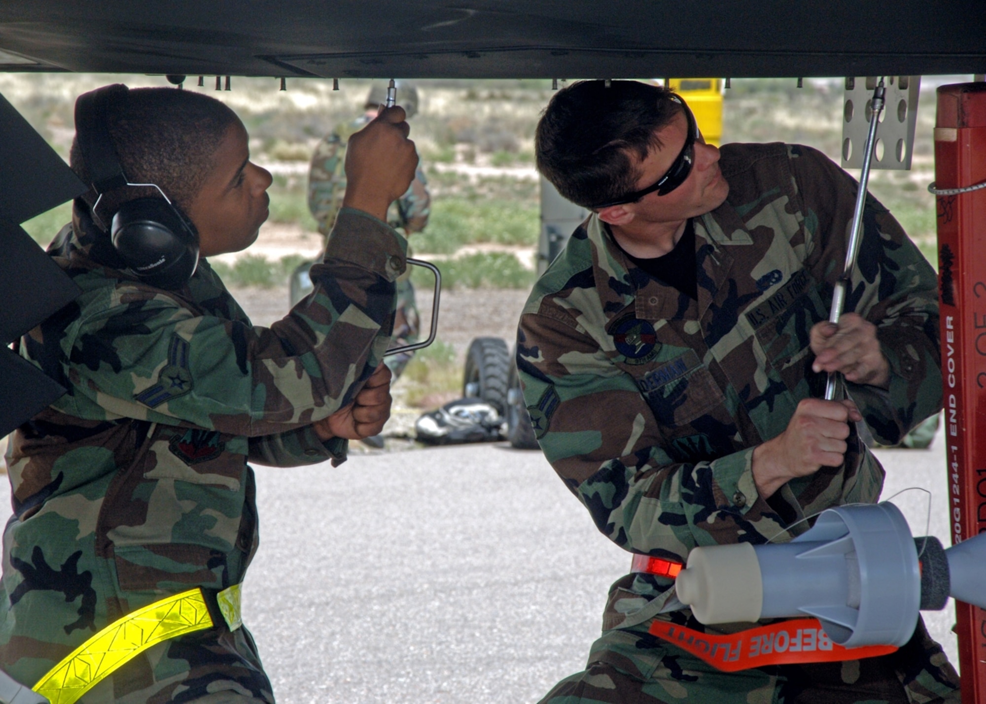 Airmen 1stClass Brandon Meyers and Justin Lederman, 49th Aircraft Maintenance Squadron, do routine maintenance on an F-117A at Holloman to prepare the jets for the Phase II exercise. (United States Air Force photo by Airman 1st Class Tiffany Mayo)