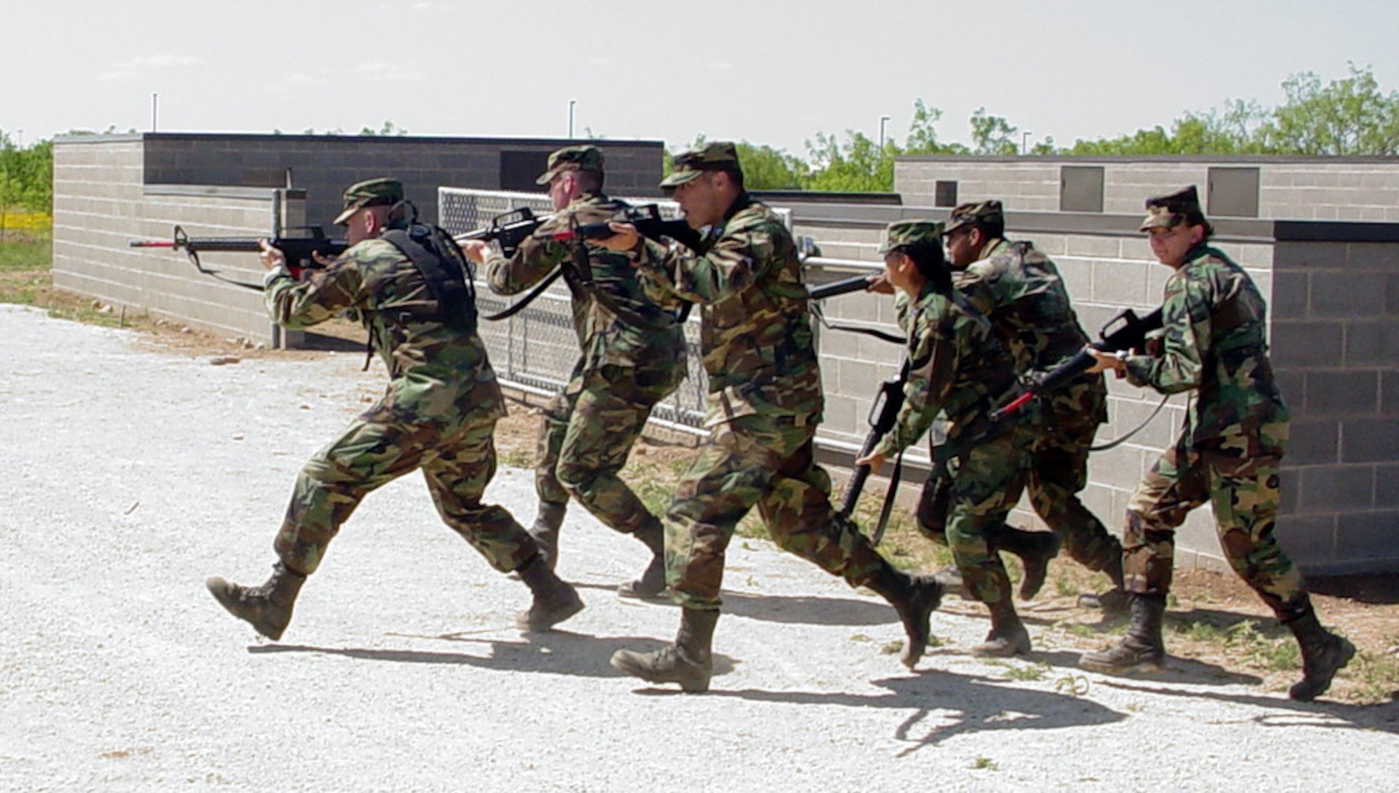 Members of Air Force Reserve Officer Training Corps Detachment 847 move forward during the town patrol procedures portion of a field training exercise at Goodfellow Air Force Base, Texas. The exercise, which took place April 28, was conducted at Goodfellow's Camp Sentinel training area. (U.S. Air Force photo by Master Sgt. Dennis McGorty)