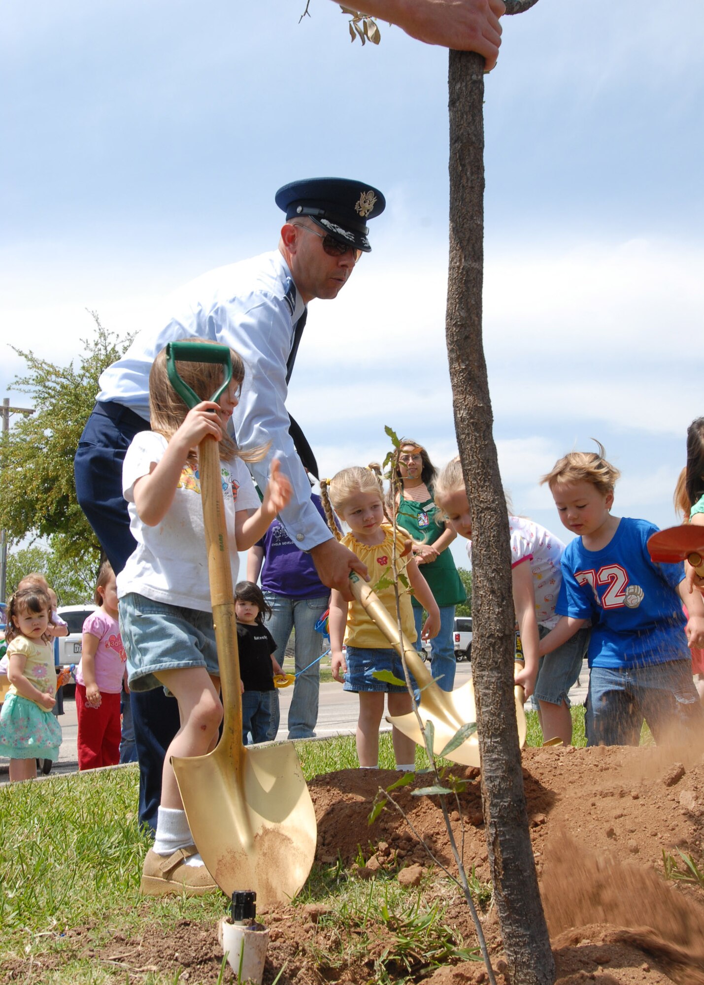 Col. Stephen Czerwinski, 17th Mission Support Group commander, digs in while helping to plant a tree during the Child Development Center’s Arbor Day celebration April 27.  (U.S. Air Force photo by Staff Sgt. Angela Malek)