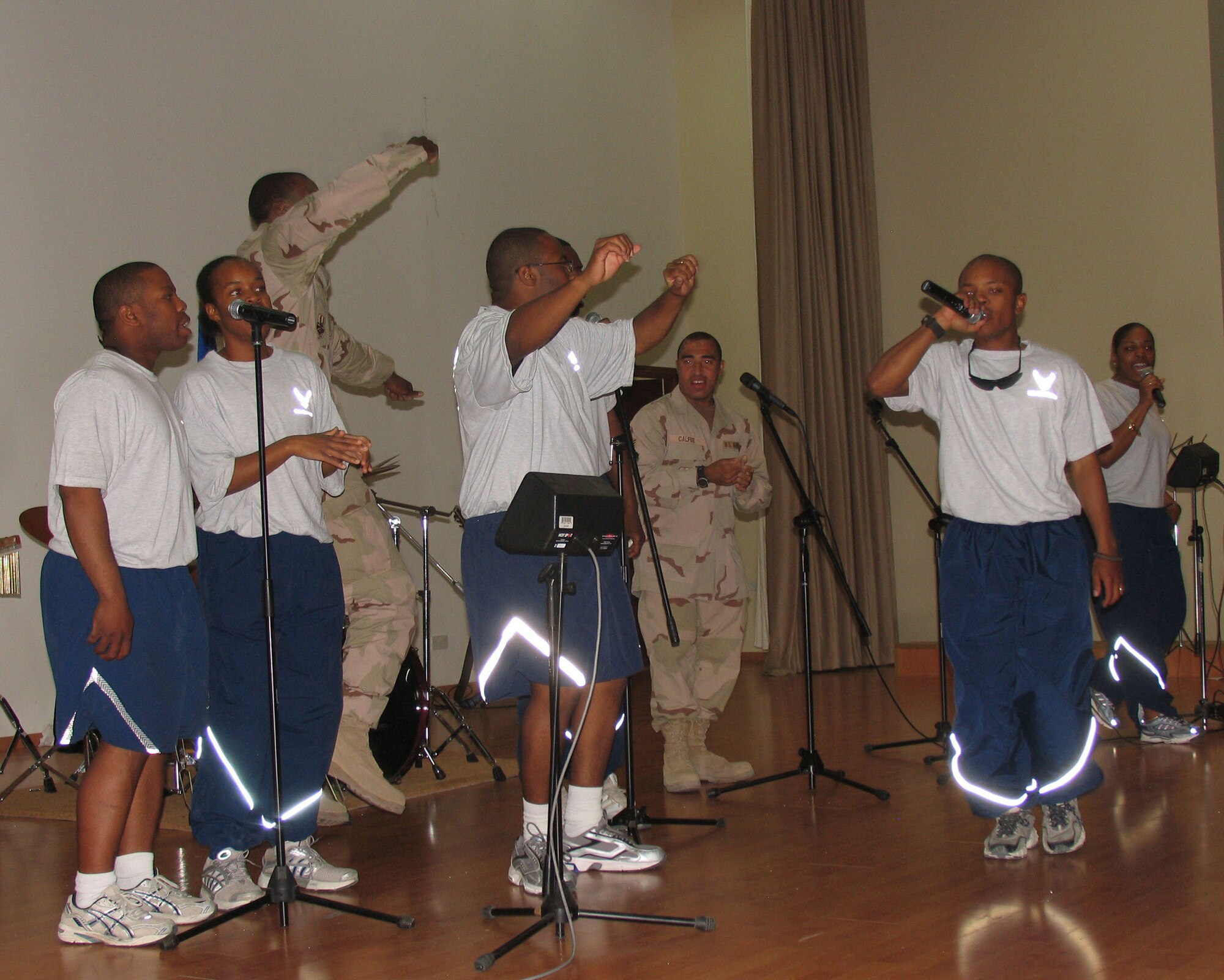 Staff Sgt James Hargrave, 386 ESFS, leads the Gospel Choir in a praise song during the May 4th Gospel Festival at an undisclosed location in Southwest Asia. The Gospel Festival, sponsored by the 386 AEW Chapel, was a praise and worship celebration comprised of various choirs, soloists and performers. (AF/Photo Capt.Rickardo Bodden)    