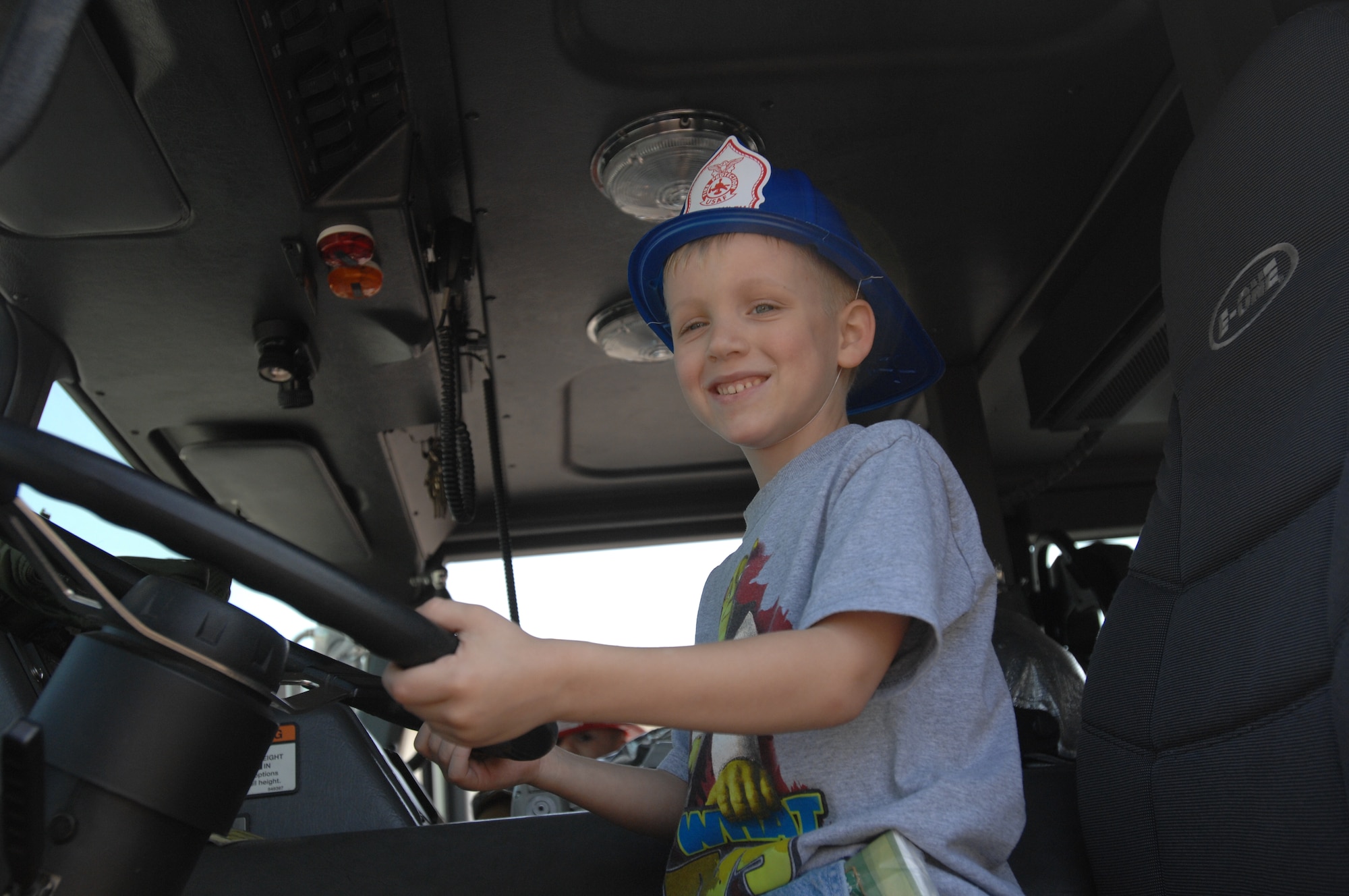 SPANGDAHLEM AIR BASE, GERMANY -- Trevor Ridout, 7, son of Staff Sgt. Brandon Ridout, 52nd Communications Squadron, gave the firefighters of the 52nd Civil Engineer Squadron a break when he “took over” as driver during the block party. (US Air Force photo/Airman 1st Class Emily Moore)