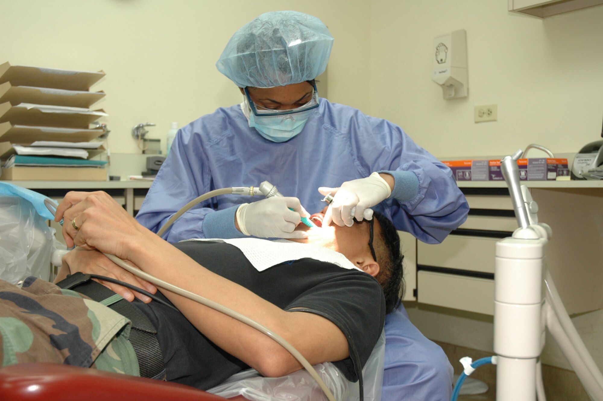 OSAN AIR BASE, Republic of Korea --  Staff Sgt. Priscilla Clark, 51st Dental Squadron dental technician, performs a routine teeth cleaning at the dental clinic here May 1. Dental technicians must complete nine and a half weeks of technical training at Sheppard AFB, Texas. (U.S. Air Force photo by Staff Sgt. Benjamin Rojek)