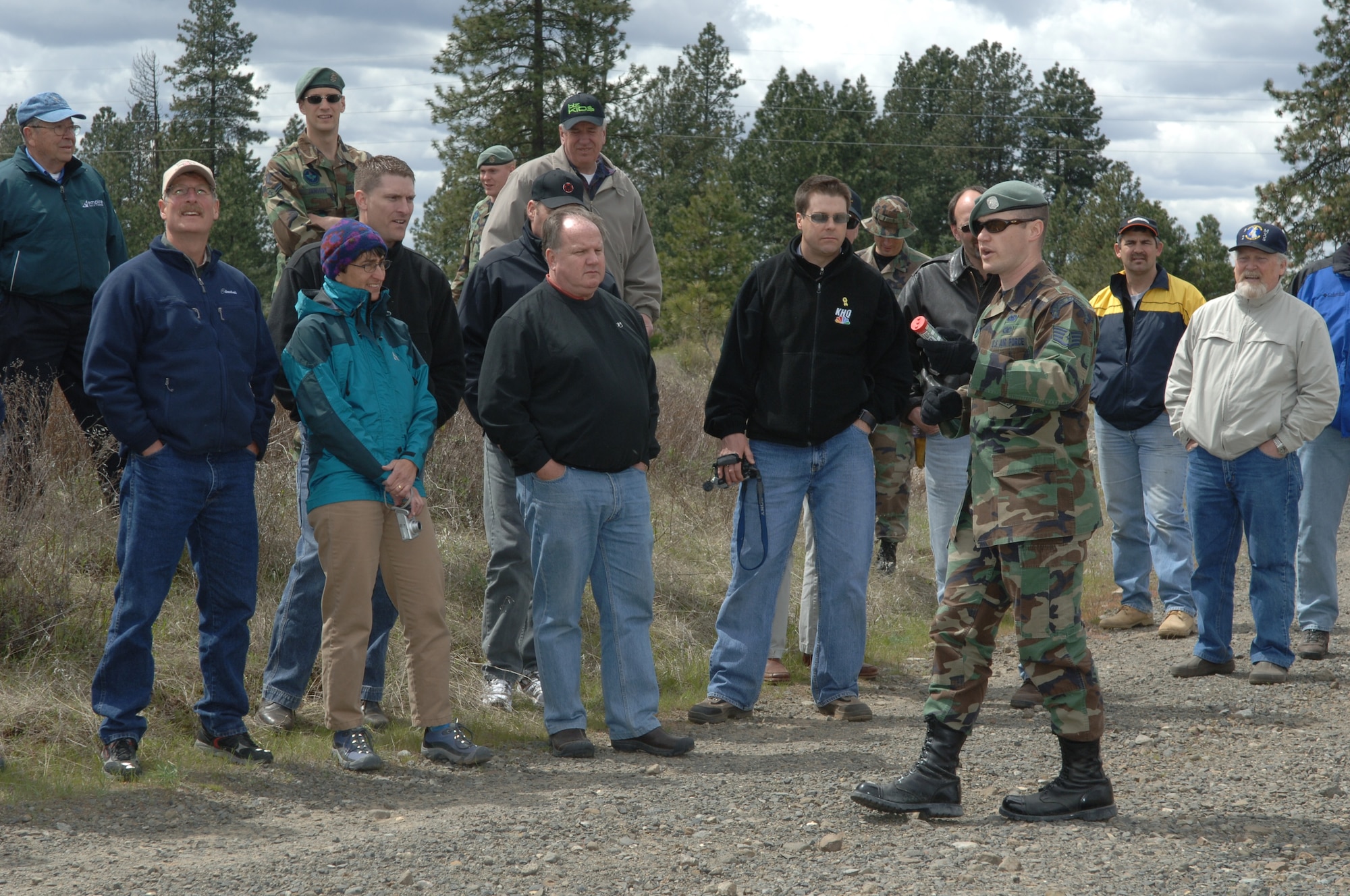 FAIRCHILD AIR FORCE BASE, Wash. -- Staff Sgt. Joseph White, 22nd Training Squadron, demonstrates a signaling flare to Fairchild Honorary Commanders and Eagles during a tour of the 336th Training Group Friday. The tour included many aspects of the Survival, Evasion, Resistance and Escape School training program. (U.S. Air Force Photo/Airman 1st Class Jocelyn Ford)