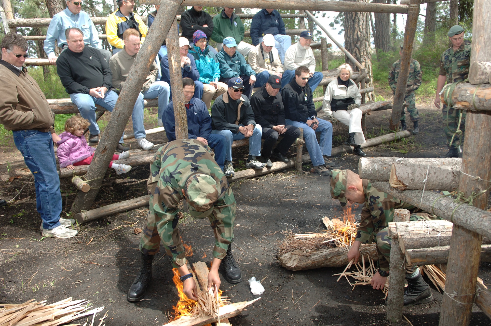 FAIRCHILD AIR FORCE BASE, Wash. -- Students at the Survival, Evasion, Resistance and Escape School demonstrate basic fire-building techniques to Fairchild Honorary Commanders and Eagles during a tour of the 336th Training Group Friday. The demonstration took place at the shelter area in the SERE school's "Back 40" training area on Fairchild. (U.S. Air Force Photo/Airman 1st Class Jocelyn Ford)