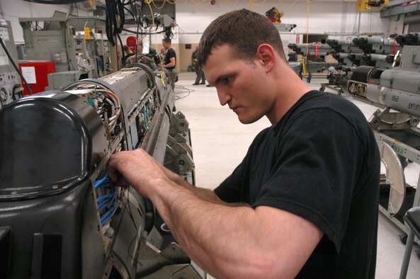 KUNSAN AIR BASE, Republic of Korea  May 7, 2007 -- Senior Airman Chad Engelman, 8th MXS electronic warfare systems journeyman, ties down electrical components in an electronic countermeasure pod May 7. Maintainers tie down the components during flight so as pilots pull high-G maneuvers, the components aren't rattled out of place. (U.S. Air Force photo/Senior Airman Stephen Collier)