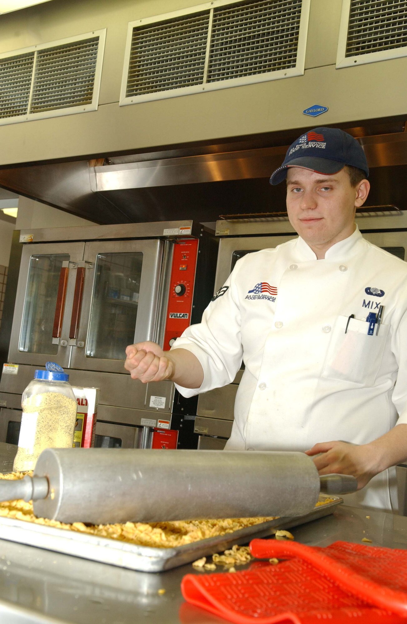 EIELSON AIR FORCE BASE, Alaska -- Airman 1st Class Jonathan Mix, 354th Force Support Squadron, prepares chicken to be seasoned and breaded with corn flakes on May 03. The Dining Facility serves over seven hundred pieces of chicken a day and over twenty thousand pieces of chicken a month.  (U.S. Air Force photo by Airman 1st Class Christopher Griffin)
