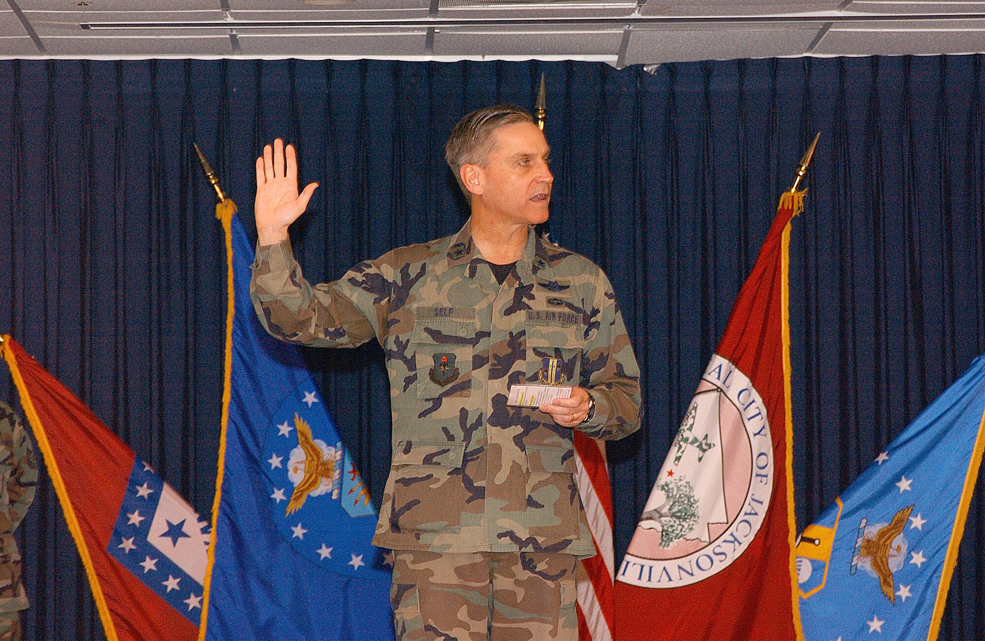 Brig. Gen. Kip Self, 314th Airlift Wing commander, administers the oath of enlistment to a group of honorary commanders at Little Rock Air Force Base. 