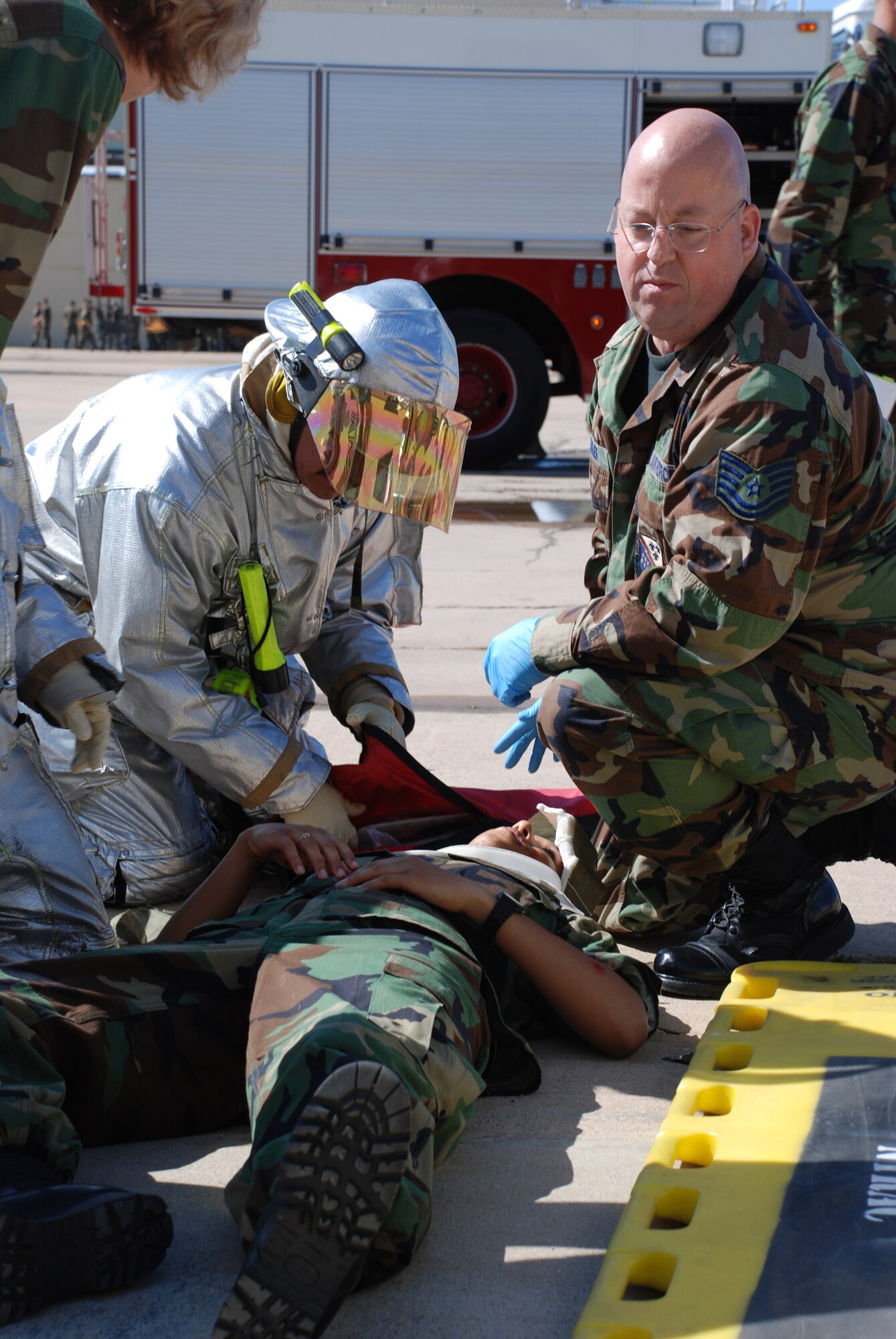 Tech. Sgt. Benjamin Barker, a medical technician with the 82nd Aerospace Medical Squadron, helps Sheppard fire department members provide care to an "injured" Airman-in-Training during the Severe Weather Response Excercise May 3.  (U.S. Air Force photo/Airman 1st Class Jacob Corbin)