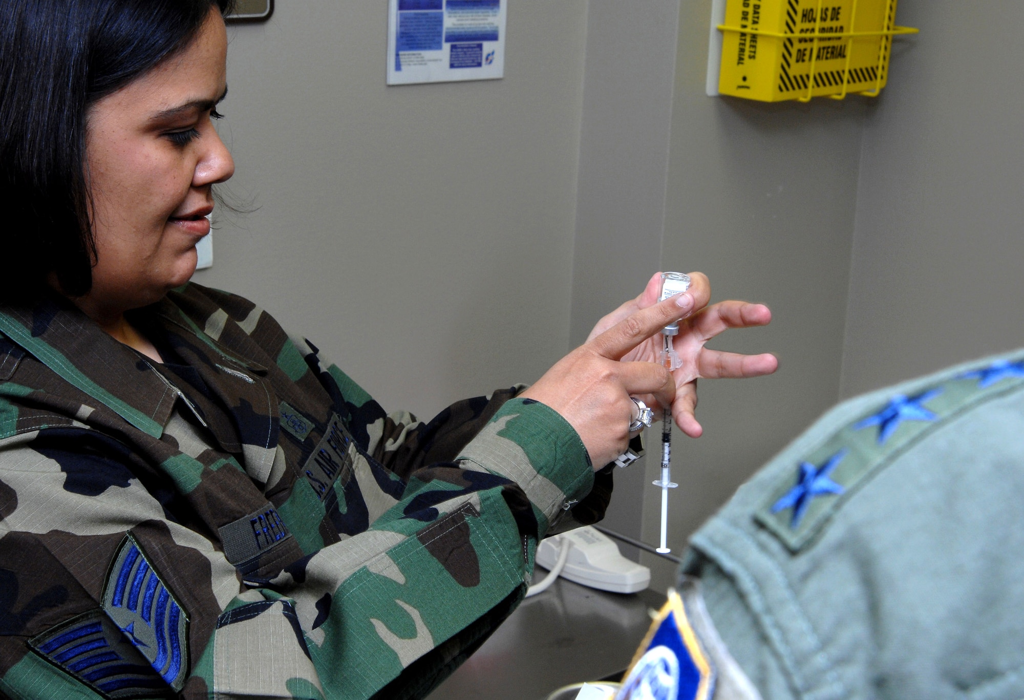 Gen. Kevin P. Chilton is prepped  to receive the anthrax vaccine from Tech. Sgt. Lori Freeman May 4 at Peterson Air Force Base, Colo. General Chilton is the commander of Air Force Space Command, and Sergeant Freeman is a medical technician with the 21st Medical Operations Squadron. (U.S. Air Force photo/Duncan Wood) 
