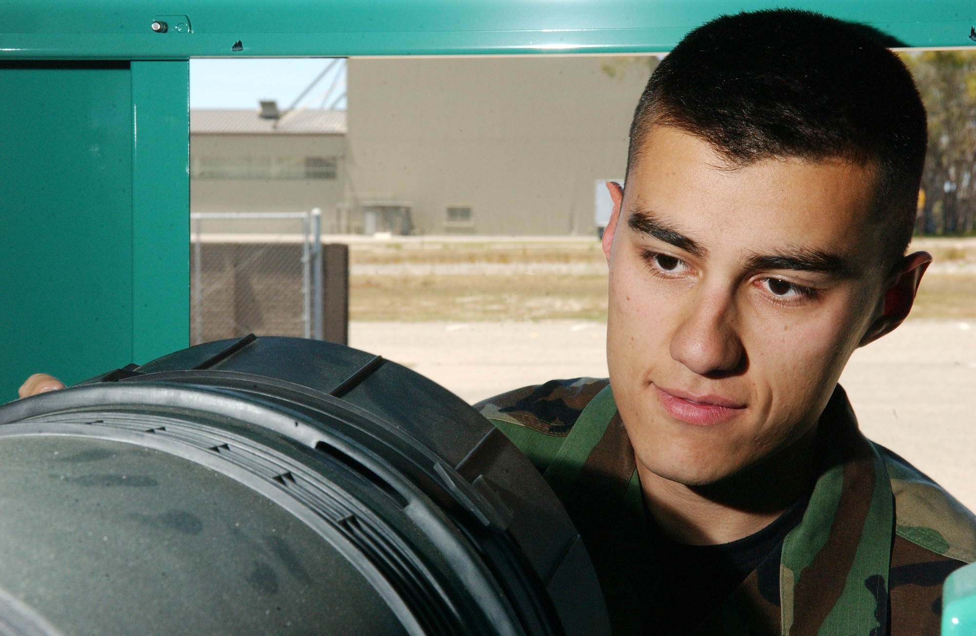 Staff Sgt. Cahramon Pulatov inspects a generator during a pre-operational maintanence inspection at Vandenberg AFB May 7.  The power production journeyman with the 30th Civil Engineer Squadron maintains the machines like this one that generates auxiliary power and helps to ensure lighting for the Vandenberg flight line during a commercial power outage. (U.S. Air Force photo by Staff Sgt. DeNoris Mickle)