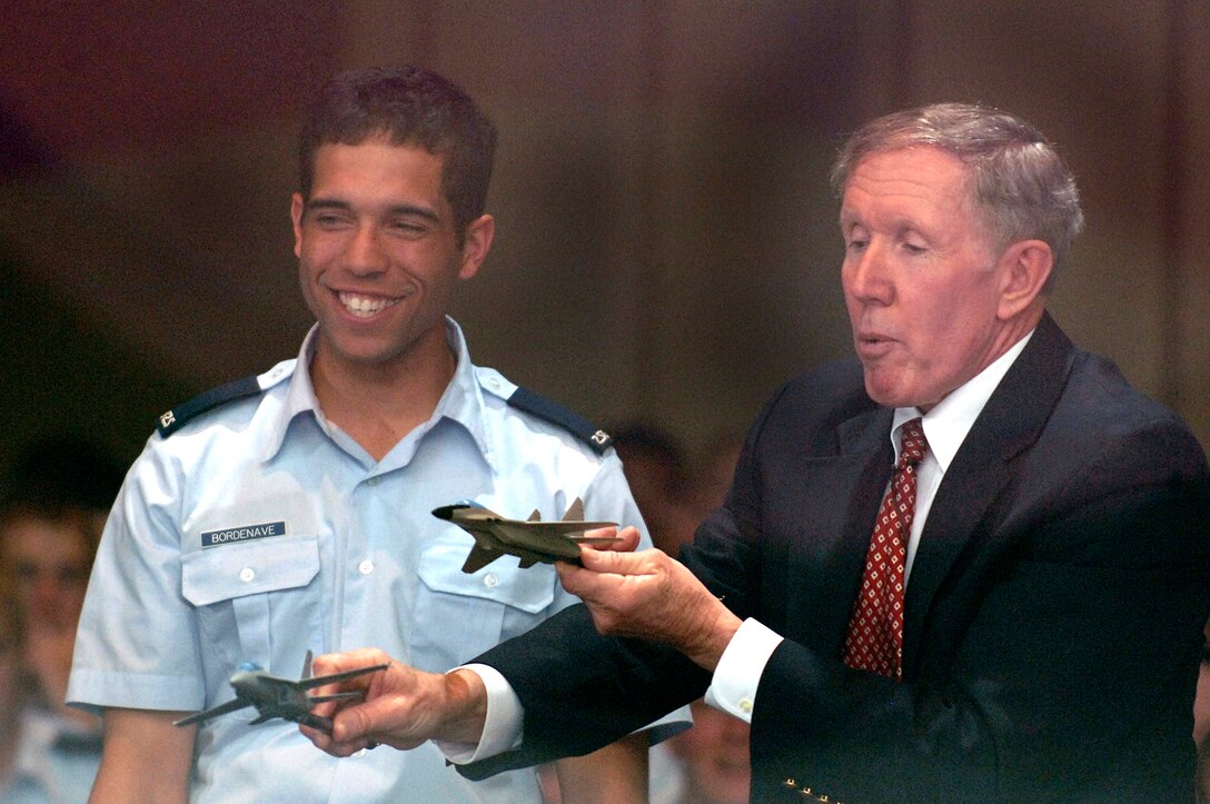Retired Navy Cmdr. William Driscoll demonstrates a dogfight to Cadet Christopher Bordenave during a motivational speech in Arnold Hall during the Academy Cadet Wing Unit Compliance Inspection in April at the U.S. Air Force Academy. (U.S. Air Force photo/Mike Kaplan) 