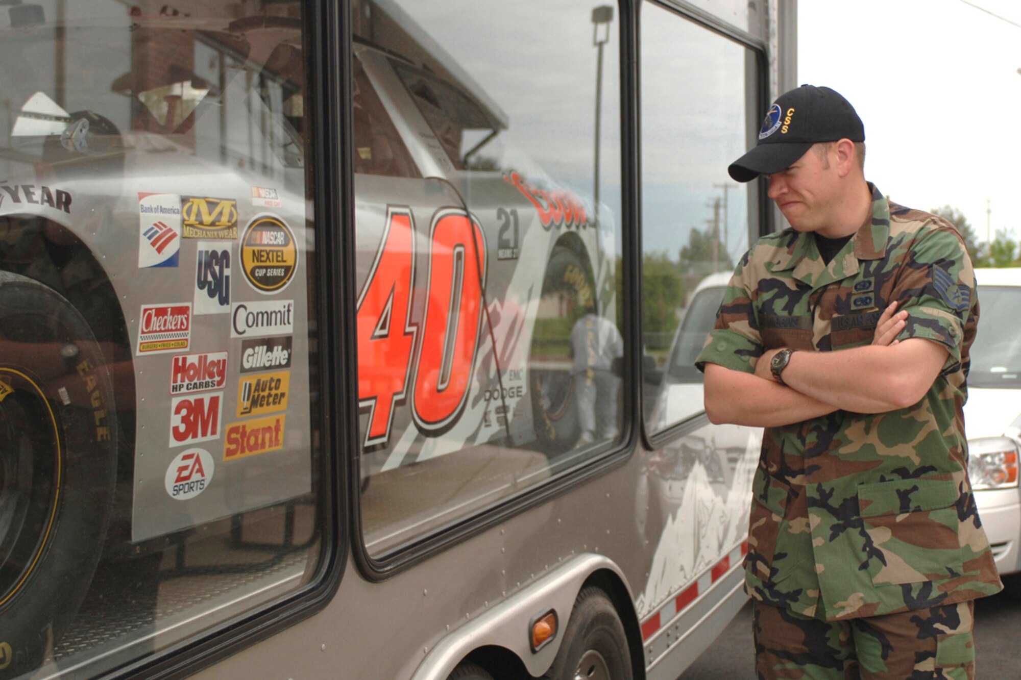 Staff Sgt. Ben Higgins, 82nd Communications Support Squadron system administrator technician, checks out the Coors Light racecar, one of the several cars on display during the grand opening of the new Langley gas station May 4. (U.S. Air Force photo/Staff Sgt. Brandy Bogart)