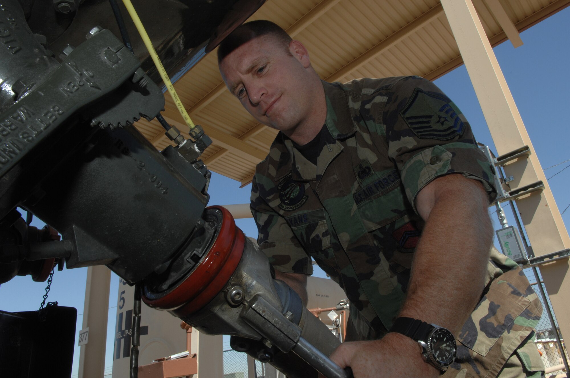 Master Sgt. Ryan Evans, 56th Logistics Readiness Squadron, hooks up a hose to an R-11 refueling truck Friday. Sergeant Evans won the 2006 Air Force Fuels Senior NCO of the Year Award. (Photo by Tech. Sgt. Jeffrey Wolfe)