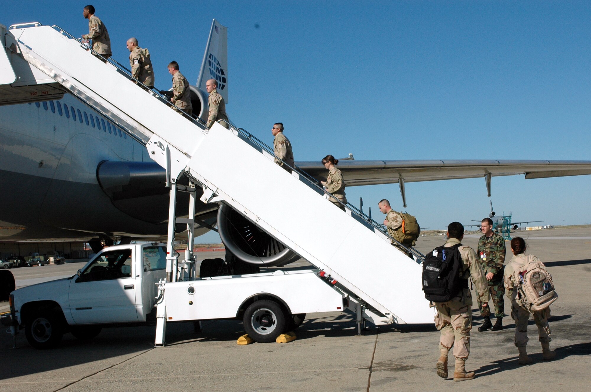 Members of Team Travis board an aircraft en-route to the Air Expeditionary Force deployments May 5. More than 100 Airmen from various Air Force bases departed Travis to different locations in support of Operations Enduring and Iraqi Freedom. (U.S. Air Force photo by Staff Sgt. Candy Knight)