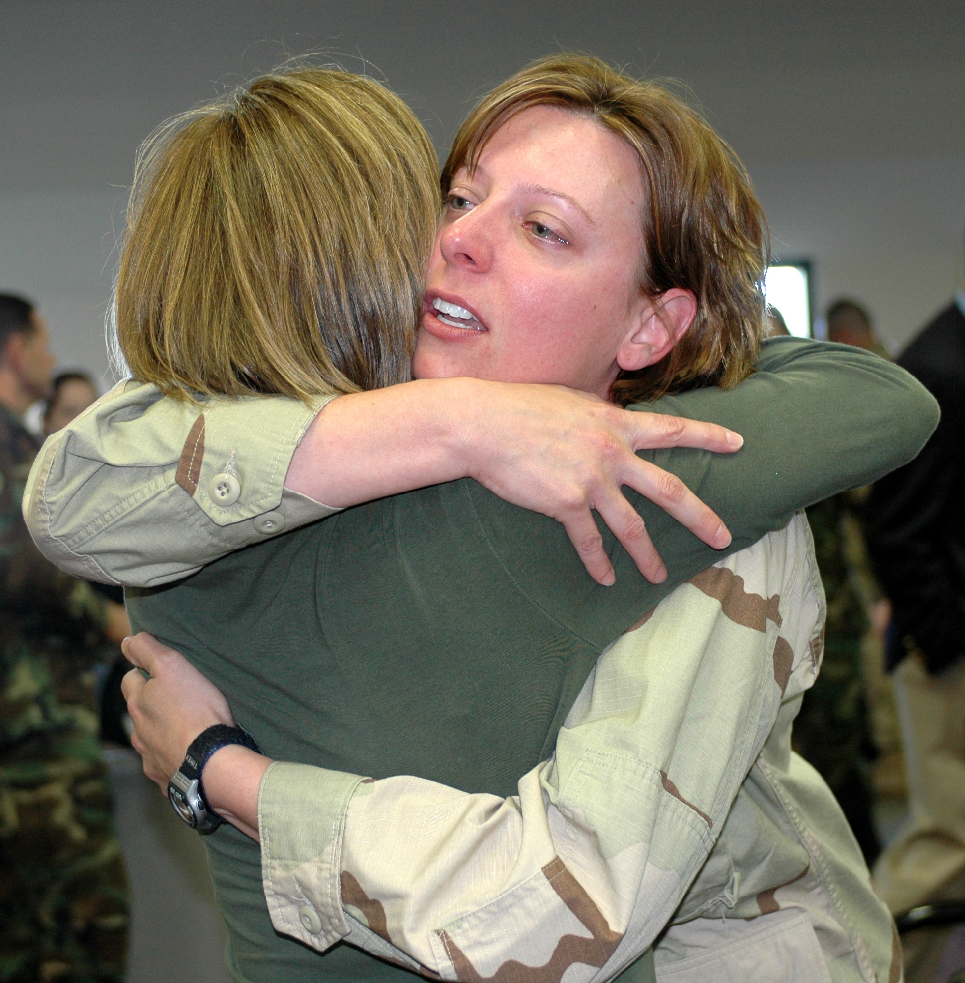 An Airman says goodbye to a family member at the Travis Passenger Terminal May 5 before departing as part of Air Expeditionary Force-cycles 7/8. More than 100 Airmen from various Air Force bases departed Travis to different locations in support of Operations Enduring and Iraqi Freedom. (U.S. Air Force photo by Staff Sgt. Candy Knight)