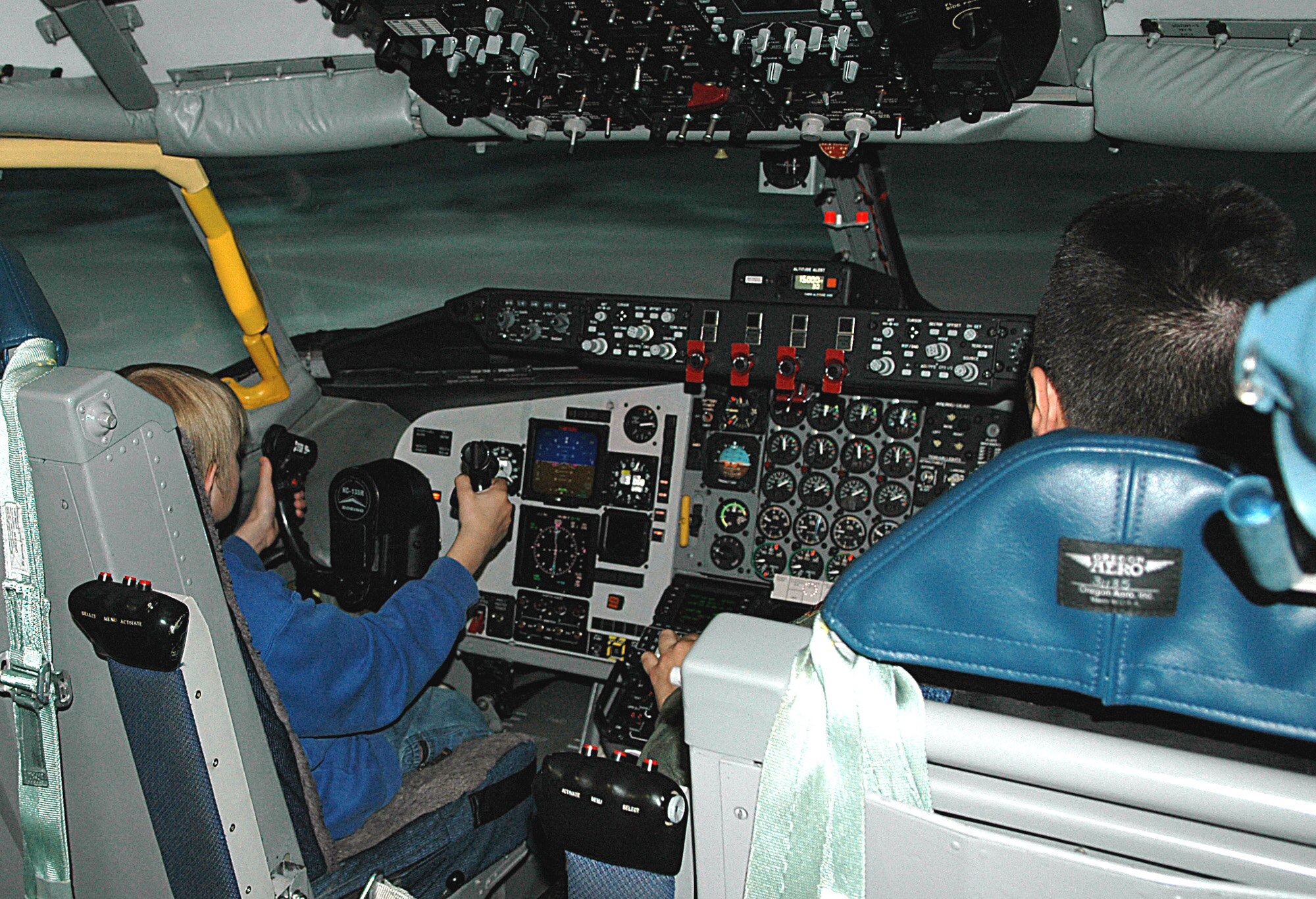 FAIRCHILD AIR FORCE BASE, Wash. -- Dylan Nickerson, 13, pilots a KC-135 in the flight simulator alongside Maj. Brian Eberling, 509th Weapons Squadron instructor pilot, during the 509th WPS’s first “Pilot for a Day” event May 3. Dylan was able to take part in the program due to coordination between the 509th WPS and the Candlelighters of the Inland Northwest, an organization that aids young cancer patients and their families. (U.S. Air Force photo/Airman 1st Class Kali L. Gradishar)