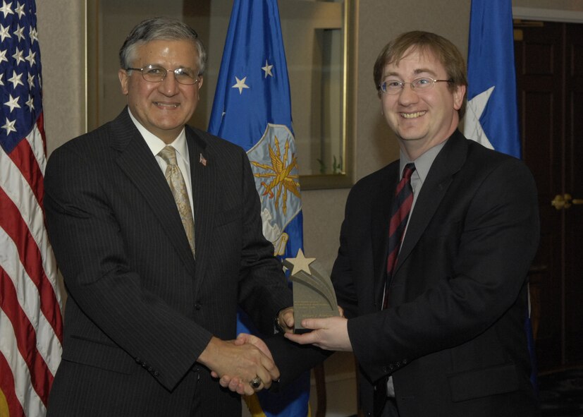 Andrew J. Stephens, 11th Wing historian, received the Outstanding Civilian Administrative Professional Award — Executive Level from Robert E. Corsi Jr., deputy administrative assistant to the Secretary of the Air Force, during a ceremony at the Bolling Clubs April 25. (U.S. Air Force photo by Senior Airman Rusti Caraker)