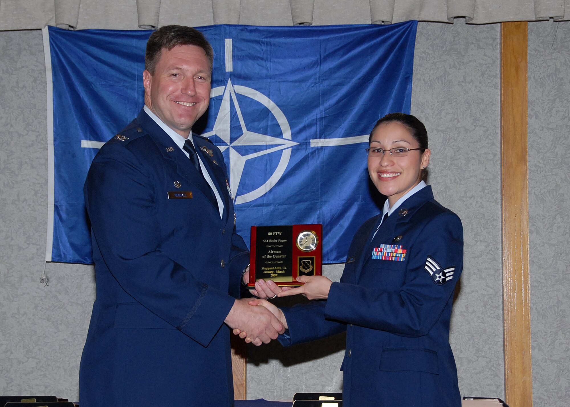 Col. Jeffrey Kendall, 80th Flying Training Wing Commander, presents Senior Airman Rose Fagan, 80th FTW, with the award for Airman of the quarter at the 80th FTW quarterly awards luncheon. (U.S. Air Force photo)