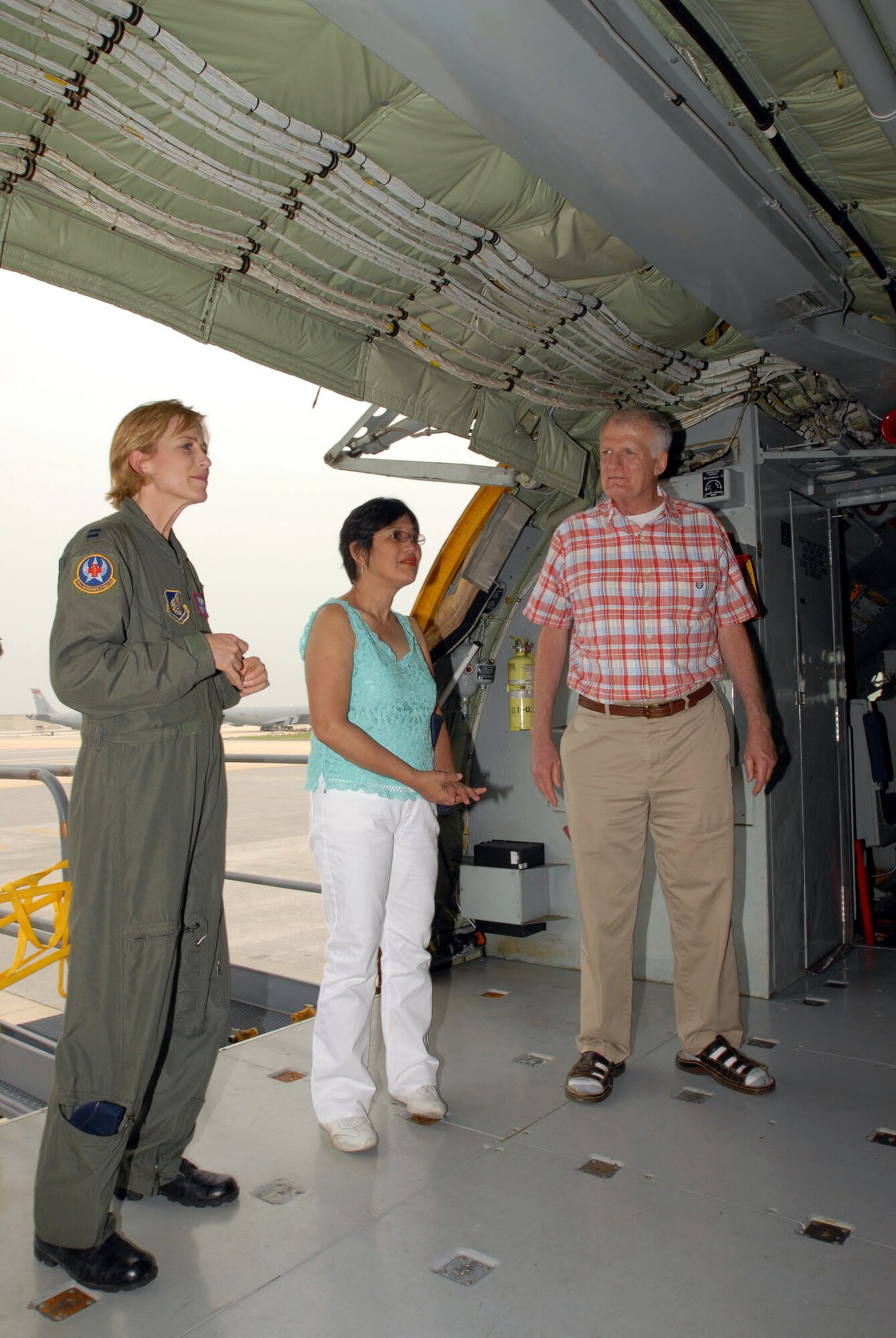 Capt. Jeannette Ward (left) talks with Jim and Marite Brierly about where Mr. Brierly's medical evacuation litter was on a KC-135 Stratotanker May 2 at Kadena Air Base, Japan. Captain Ward was part of the team that treated and medically evacuated Mr. Brierly to Hawaii after he suffered a major heart attack March 30, 2006. Mr. and Mrs. Brierly visited the units to thank them for their efforts. Mr. Brierly is a English as a second language teacher at Kadena Elementary School here. Captain Ward is a flight nurse with the 18th Aeromedical Evacuation Squadron. (U.S. Air Force photo/Airman 1st Class Kasey Zickmund) 