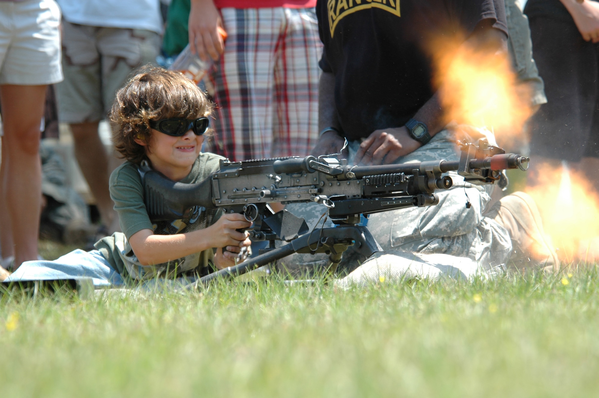CAMP RUDDER, Fla. -- Noah Yoshida, 9, of Fort Walton Beach, fires a  U.S. Army Soldiers from the 6th Ranger Training Battalion slide down a rope out of a UH-60 Blackhawk helicopter during a downed-pilot rescue demonstration at the Ranger Open House May 6. "A largest crowd ever" of people of all ages visited the 6th RTB Rangers as they brought out their equipment for hands-on displays of weapons, diving equipment, Zodiac boat, parachute, medical and a day-in-the-life display for the Ranger training school. The Army's Reptile Team put on a reptile show where people took an up-close look at venomous and non-venomous snakes that could be found just feet from where the spectators were standing. They also put on repelling demonstrations, a downed pilot rescue demonstration and a hand-to-hand combat demonstration. (U.S. Air Force photo by Staff Sgt. Mike Meares)