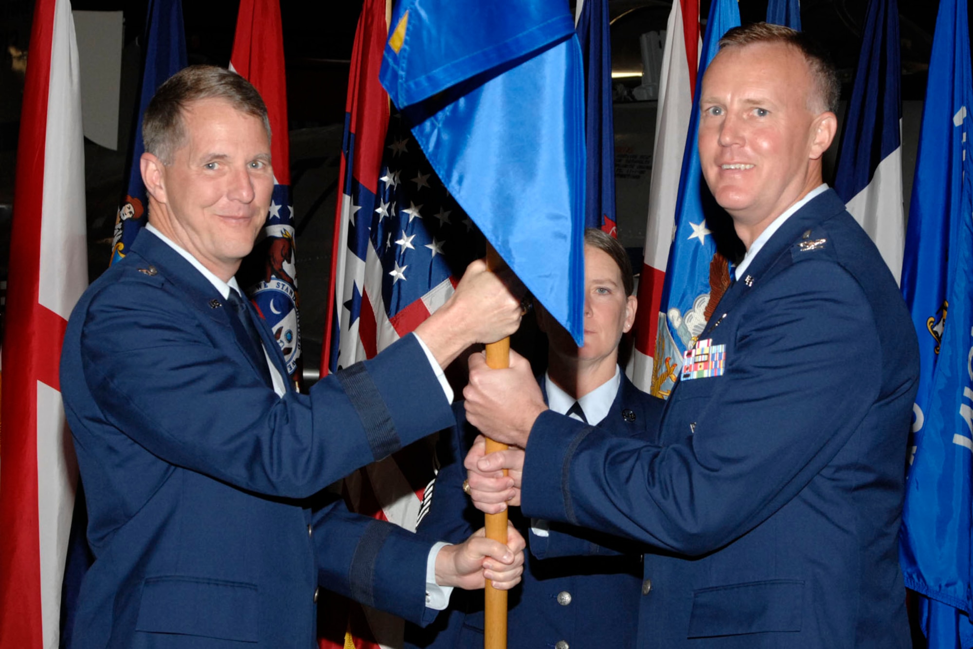 EGLIN AIR FORCE BASE, Fla. -- Brig. Gen. Ted Bowlds, Air Force Research Laboratory commander, presents Col. Kirk Kloeppel the Munitions Directorate flag during a change of command ceremony held May 4 at the Air Force Armament Museum.  (U.S. Air Force photo by Mike Fleck)
