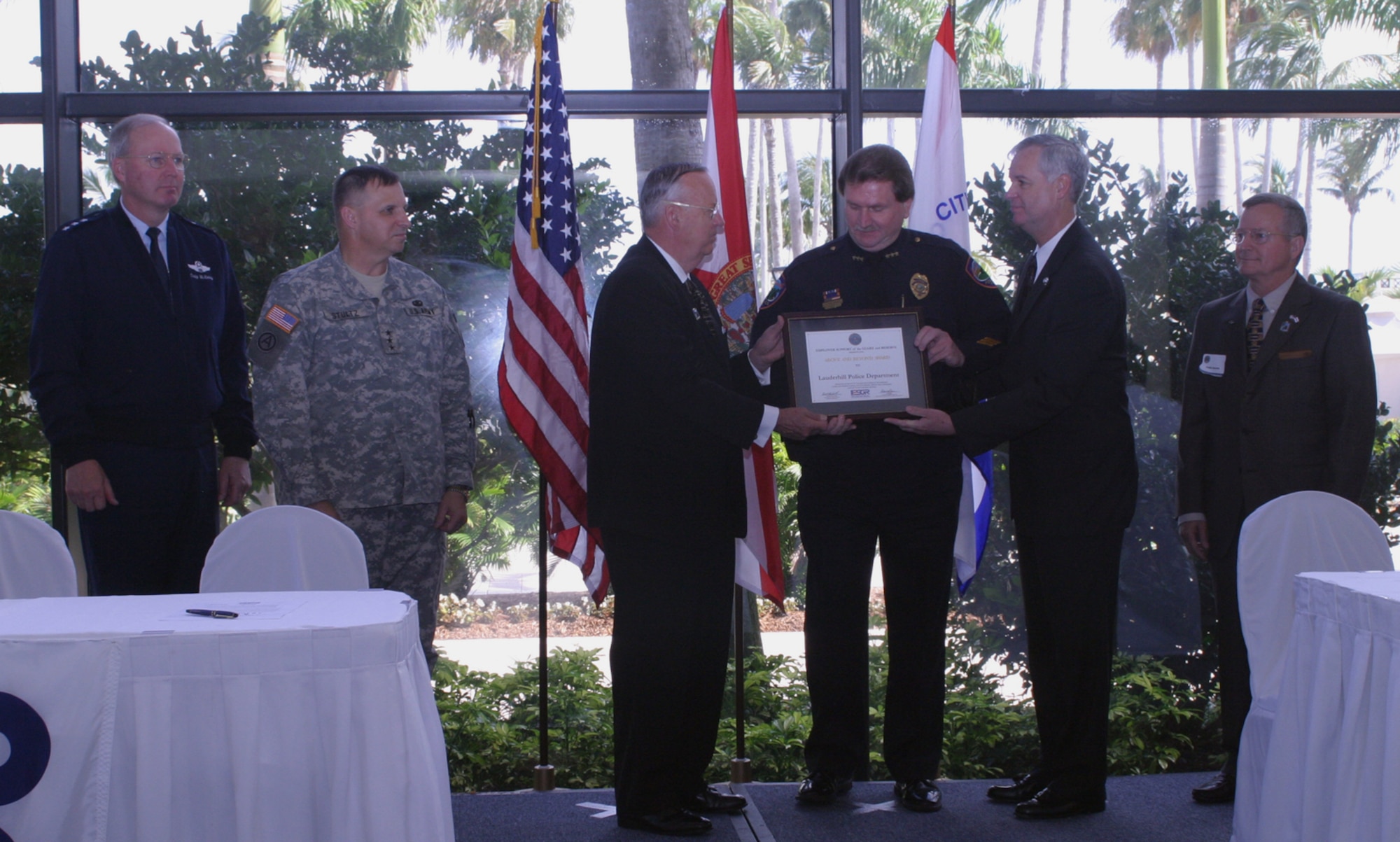 Chief Ken Pachnek, chief of police for the City of Lauderhill, is recognized by DoD representatives and National ESGR representatives during an employer support ceremony at Opa Locka airport on May 3.  From the left, Air National Guard Lt. Gen. Craig R. McKinley, director of the Air National Guard; Army Reserve Lt. Gen. Jack C. Stultz, commander of U.S. Army Reserve Command; Thomas F. Hall, assistant secretary of defense for reserve affairs; Chief Pachnek; Dr. Gordon Sumner, National Committee for Employer Support of the Guard and Reserve executive director; Phillip Speake, ESGR Florida chair. Chief Pachnek was one of a select few civilian employers who was awarded the ESGR’s Above and Beyond award in recognition of his support for military reservists who work for him at the City of Lauderhill police department. (U.S. Air Force photo/Tech. Sgt. Paul Dean)