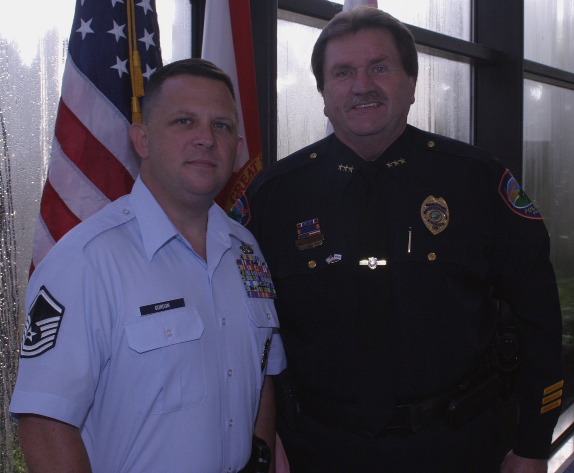 Master Sgt. William Gordon, an Air Force reservist with the 482nd Fighter Wing Security Forces Squadron stands proudly with his civilian employer, Ken Pachnek, chief of police for the City of Lauderhill. Pachnek was awarded the Above and Beyond award by the National Committee for Employer Support of the Guard and Reserve during a ceremony on May 3.  The Above and Beyond award is presented to civilian employers who find innovative ways to support activated reservists when they perform their military duties, such as attending or sponsoring welcome home ceremonies, supporting military families, and providing income-replacement assistance during activations for military service. (U.S. Air Force photo/Tech. Sgt. Paul Dean)