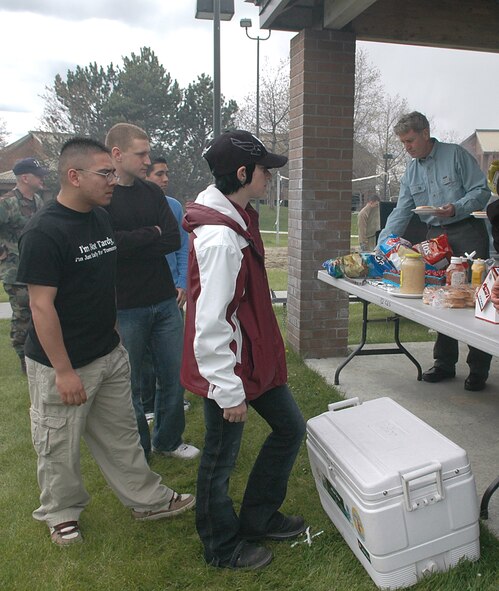 FAIRCHILD AIR FORCE BASE, Wash. -- Fairchild dorm residents line up to get some food at the dorm barbecue, which was held behind the Warrior Dining facility May 4. The first sergeants provided hamburgers, cheeseburgers, bratwursts, chips, cake, and drinks to Airmen residing in the dorms. (U.S. Air Force photo/Airman 1st Class Kali L. Gradishar)