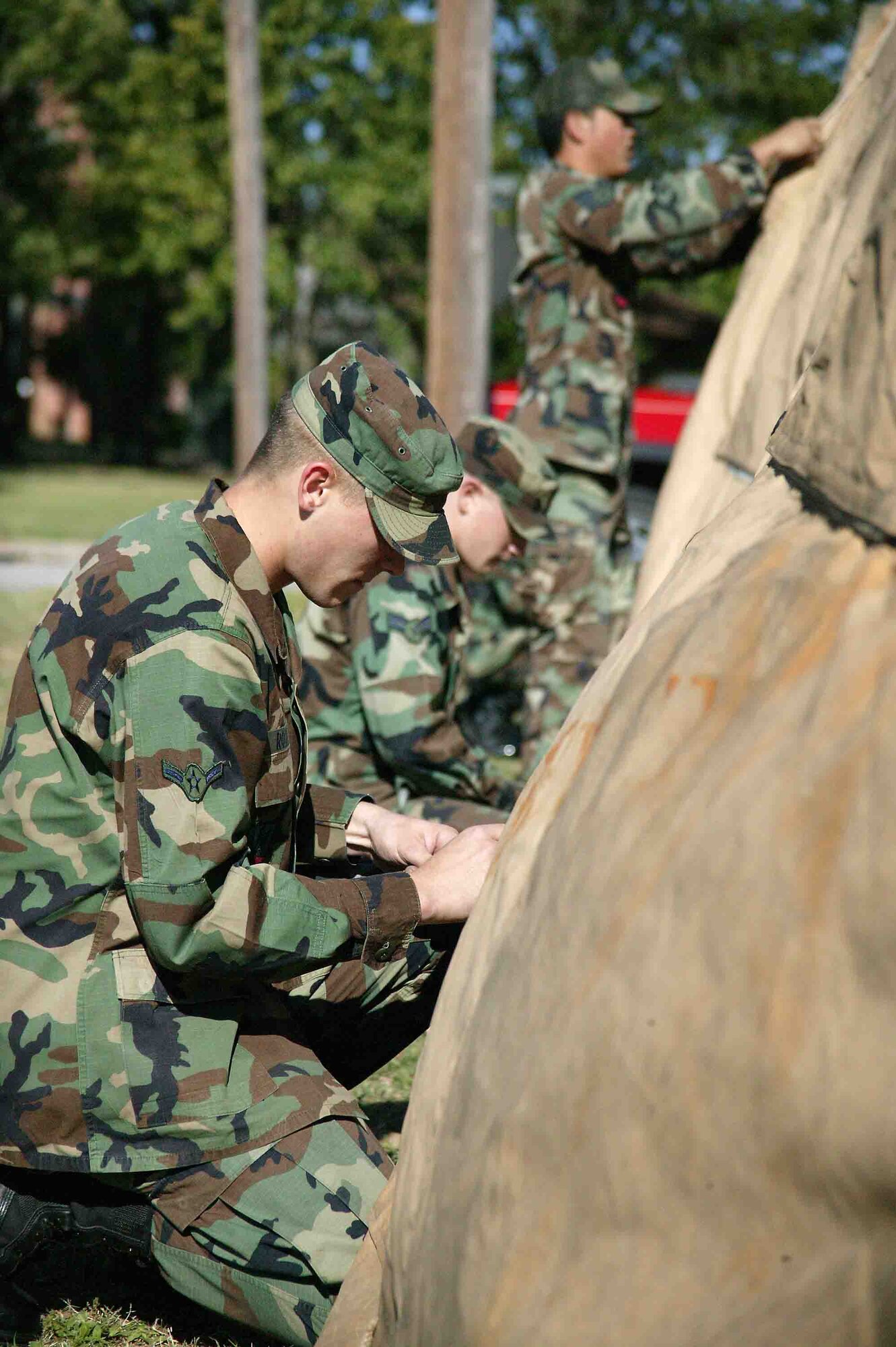 SHAW AIR FORCE BASE, S.C. -- Airman Harrison Rooks, 20th Civil Engineer Squadron, and other Airmen put up a tent May 7 in preparation for the Phase II exercise. The exercise evaluates an Airman's ability to operate and survive in a deployed location. (U.S. Air Force photo/Senior Airman John Gordinier)