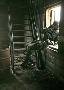 After repelling off the outer wall, 1st Lt. Stephen Addington swings through the open window of a target building during Emergency Services Team training May 4 at Lackland Air Force Base, Texas. Lieutenant Addington was on the team that competed at the Southeast Texas SWAT Competition April 24 in Beaumont, Texas. The Lackland AFB team placed first in the competition. (U.S. Air Force photo/Robbin Cresswell)
