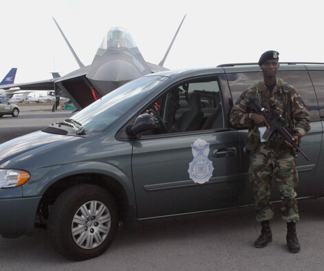Tech. Sgt. Eugene Smith guards the newest item in the Air Force inventory, the F-22 Raptor.  This year is the third time Sergeant Smith has volunteered to perform security duties at Opa Locka airport during the McDonald’s Air and Sea Show in Ft. Lauderdale, Fla.  Sergeant Smith is a member of Air Force Reserve Command’s 482nd Fighter Wing Security Forces Squadron at Homestead Air Reserve Base.   He and fellow reservists provided security for all visiting aircraft during the four-day event which attracted more than two million visitors.  (U.S. Air Force photo/Tech. Sgt. Paul Dean)