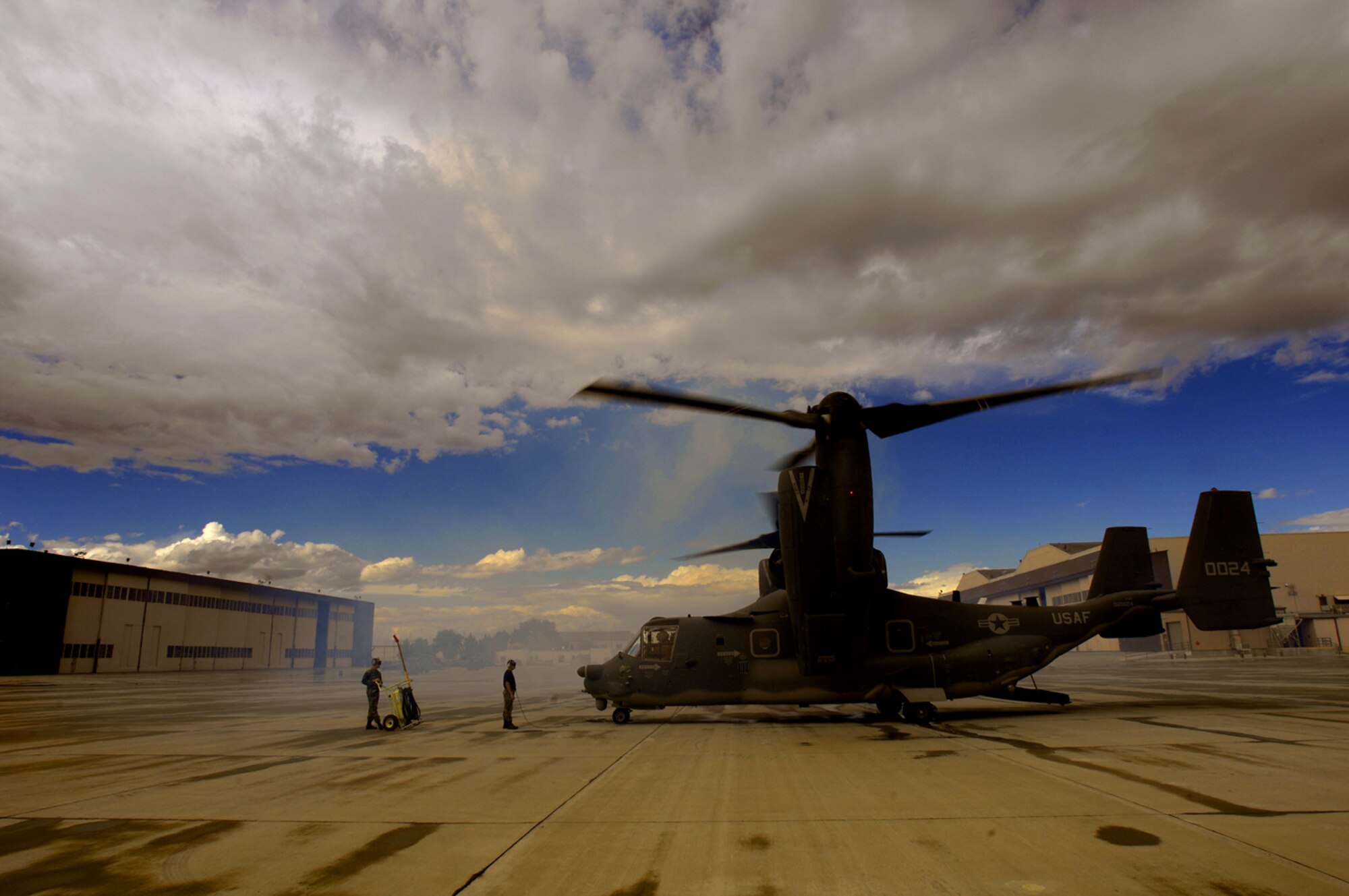 Gentlemen, start your engines! Staff Sgt. Jason Hall (right) and Tech. Sgt. Dennis Bracey, with the 71st AMU, signal a CV-22 pilot to start engines prior to taking off for a 
mission at Kirtland. (Photo by Tech. Sgt. Matthew Hannen)