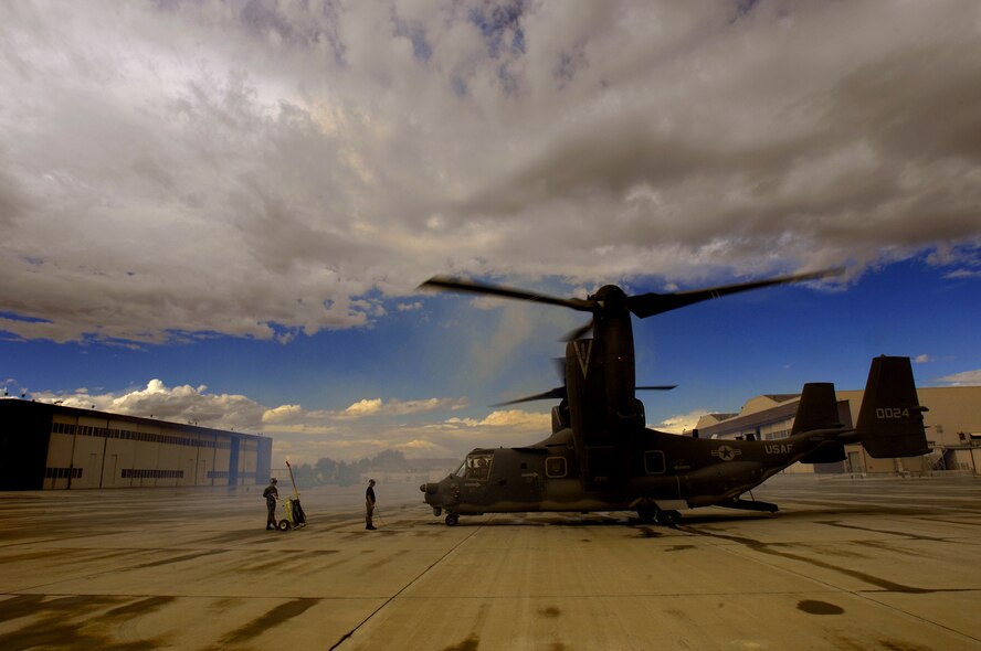 Gentlemen, start your engines! Staff Sgt. Jason Hall (right) and Tech. Sgt. Dennis Bracey, with the 71st AMU, signal a CV-22 pilot to start engines prior to taking off for a mission at Kirtland. (Photo by Tech. Sgt. Matthew Hannen)