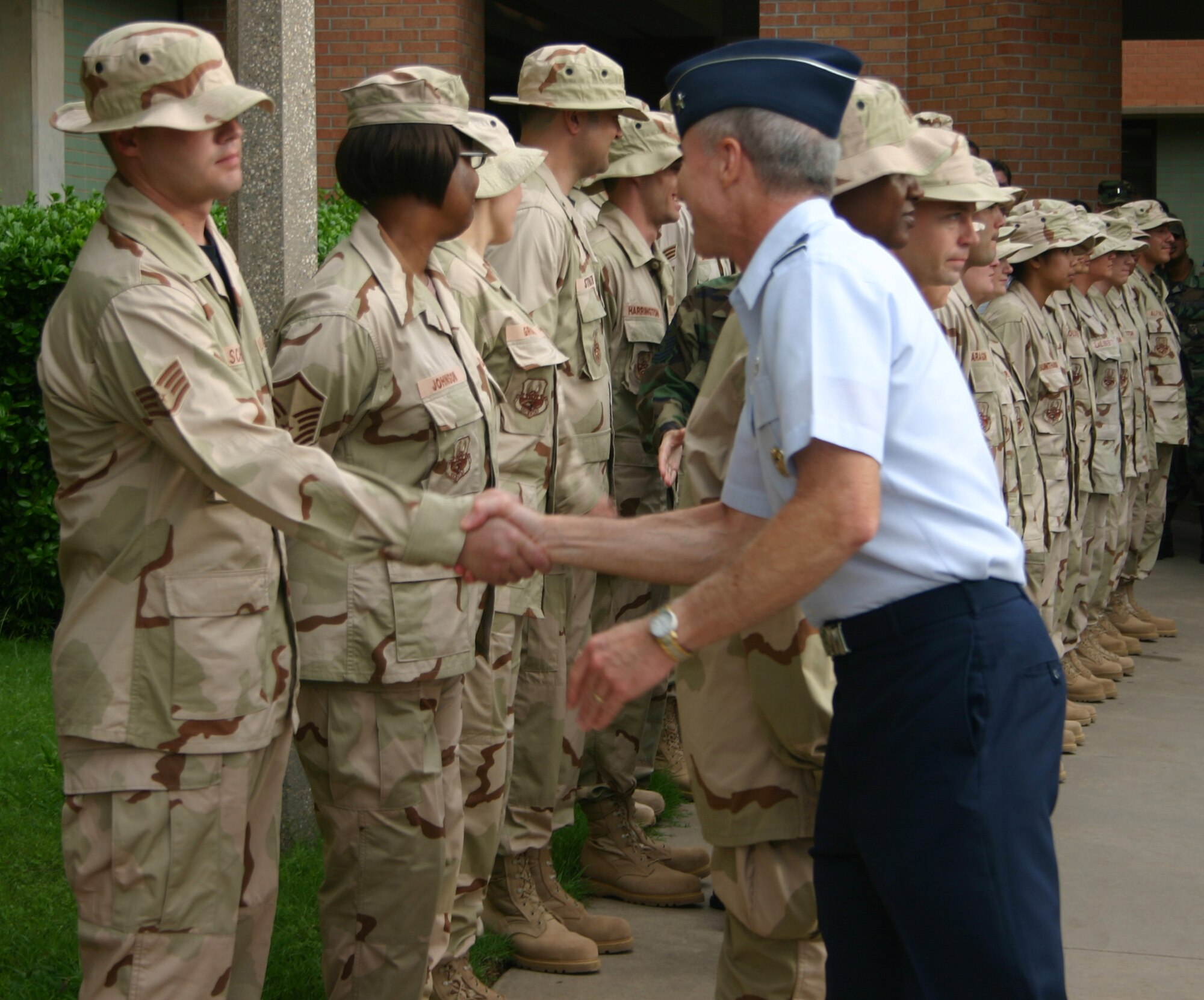 Brig. Gen. Richard Devereaux, 82nd Training Wing commander, gives well wishes to Staff Sgt. Tim Schnur before he and 26 other Sheppard medical personnel board a bus on the first leg of their deployment. Sergeant Schnur is a pharmacy technician instructor at the 882nd Training Group. (U.S. Air Force photo/John Ingle)