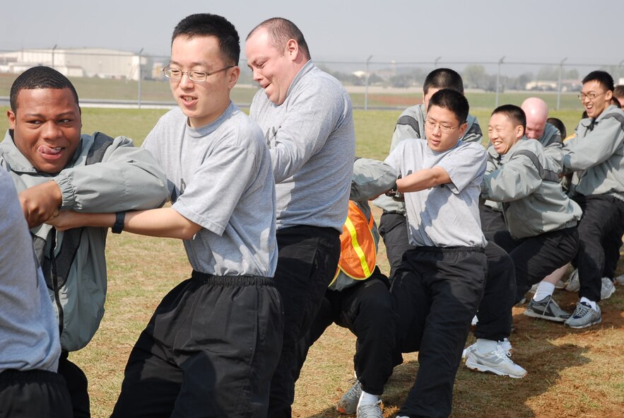 OSAN AIR BASE, Republic of Korea --  A group of U.S. soldiers and Korean Augmentee to the U.S. Army soldiers pull together in a tug-of-war match during the Korean Augmentees to the U.S. Army-U.S. Soldier Friendship Week. Despite their efforts, the team lost both matches.  
